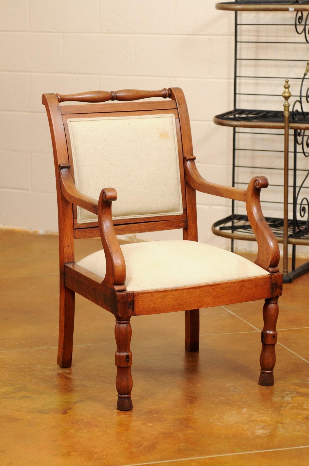 Mid-19th century provincial French Fauteuil / open arm chair in walnut with unusual scroll arms and turned back rail and legs (front).