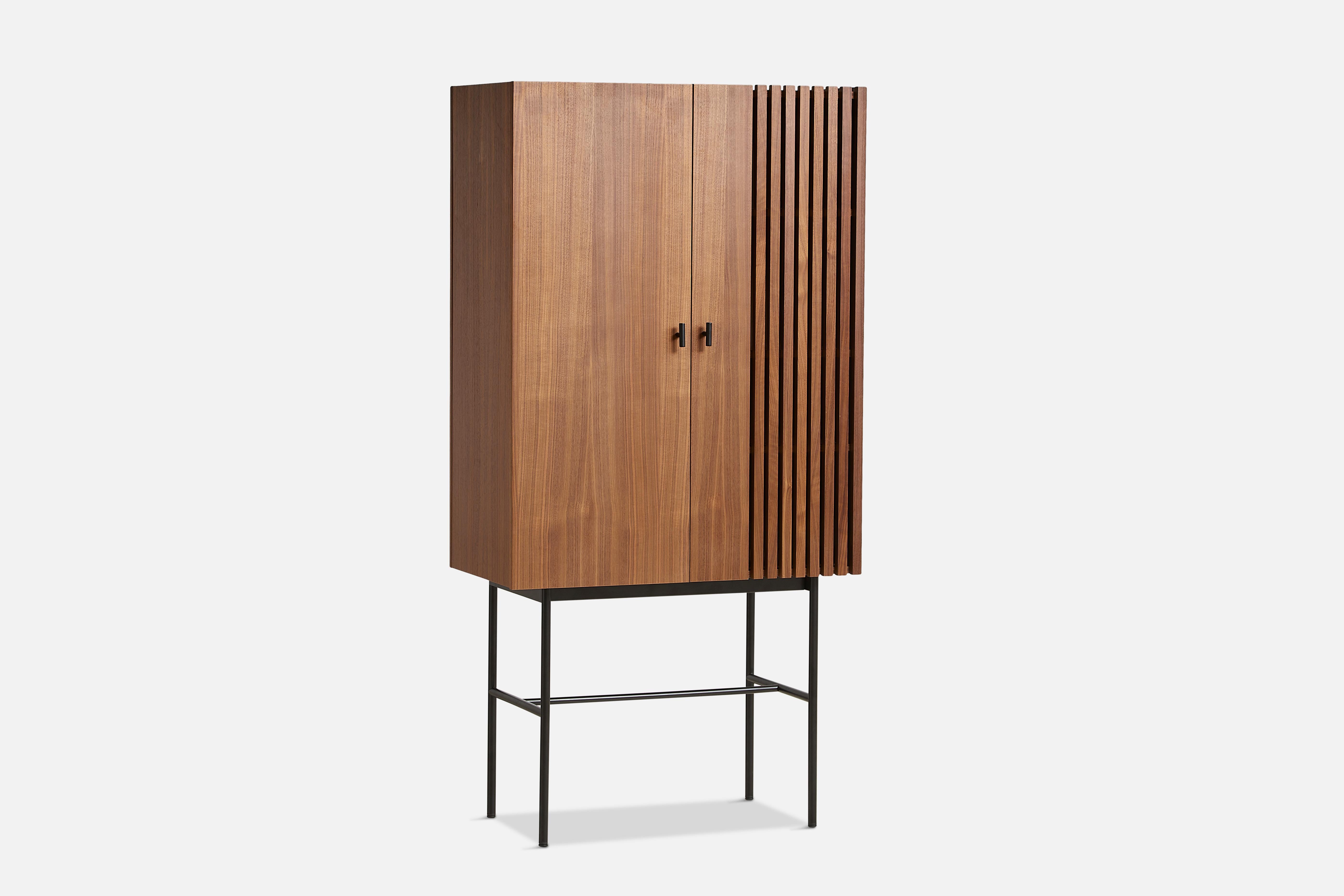 Walnut array highboard 80 by Says Who.
Materials: Walnut, metal.
Dimensions: D 44 x W 80 x H 160 cm.
Also available in different colours and materials.

The founders, Mia and Torben Koed, decided to put their 30 years of experience into a new
