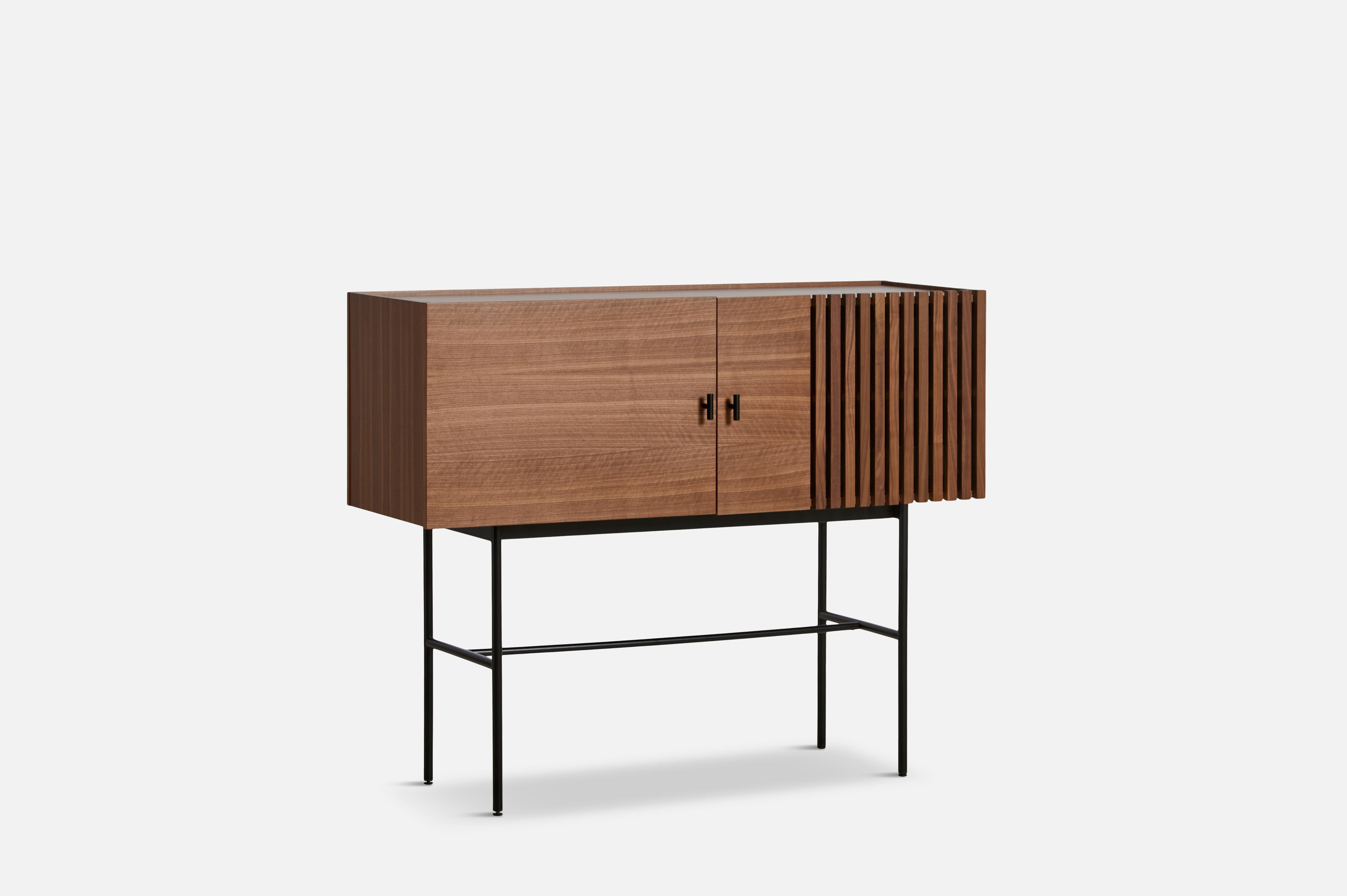 Walnut array sideboard 120 by Says Who.
Materials: Walnut, metal
Dimensions: D 44 x W 120 x H 97 cm
Also available in different colours and materials.

The founders, Mia and Torben Koed, decided to put their 30 years of experience into a new