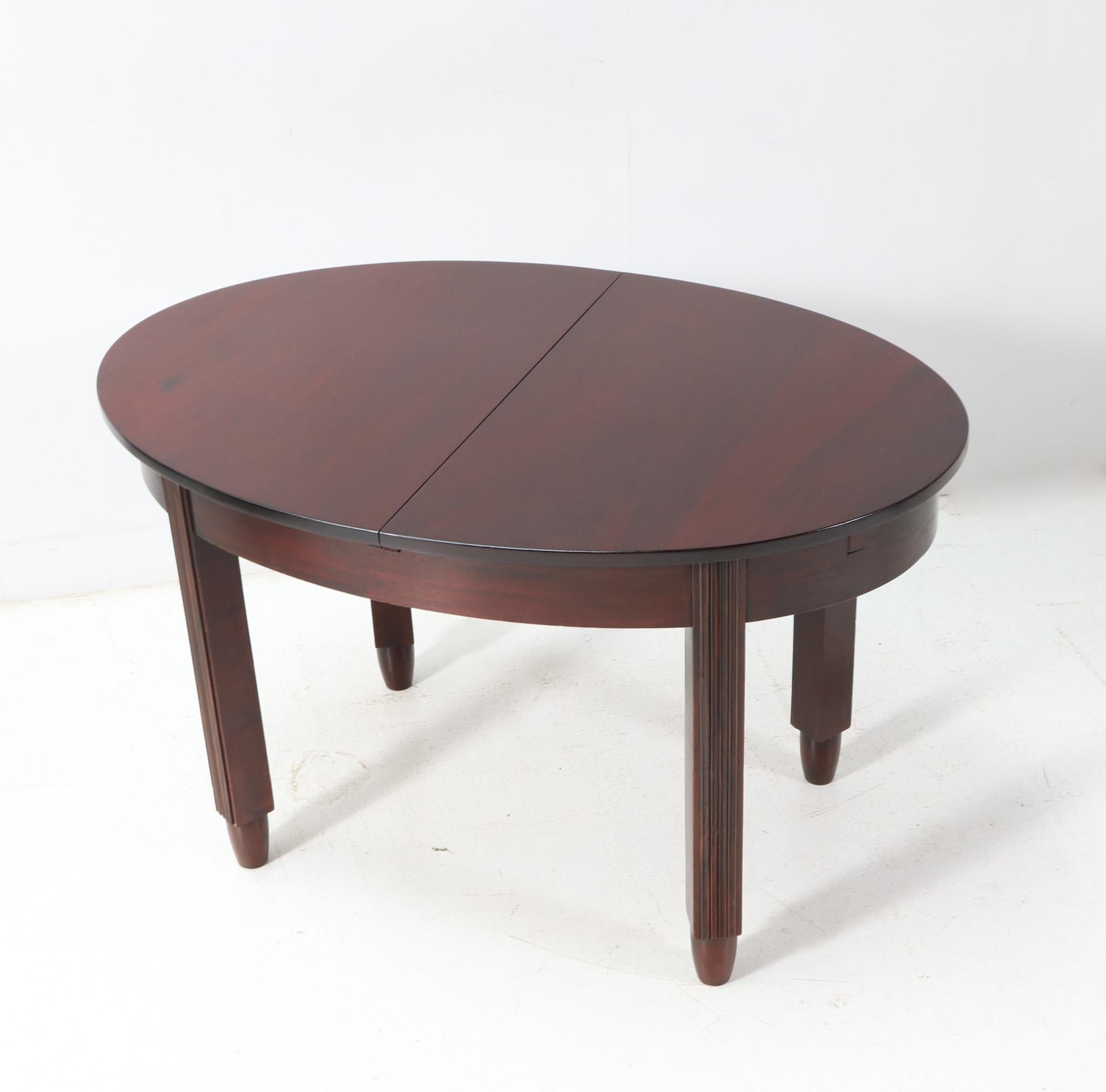 Stunning and rare Art Deco Amsterdamse School extendable dining room table.
Design by Fa. Drilling Amsterdam.
Striking Dutch design from the 1920s.
Solid walnut base with solid macassar ebony decorations at the front of the four legs.
Original solid