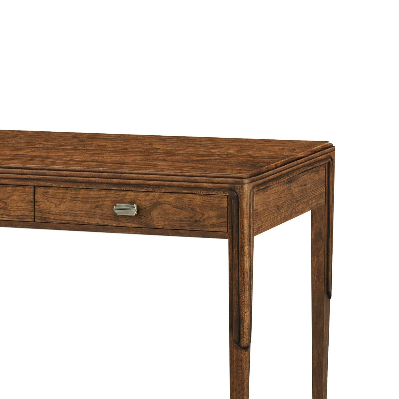Outlined in a sleek, stepped motif, this exquisite piece is finished in a rich figured walnut, exuding warmth and sophistication. The streamlined form, tapered legs, and metal-capped feet pay homage to the iconic Art Deco era, making this desk a