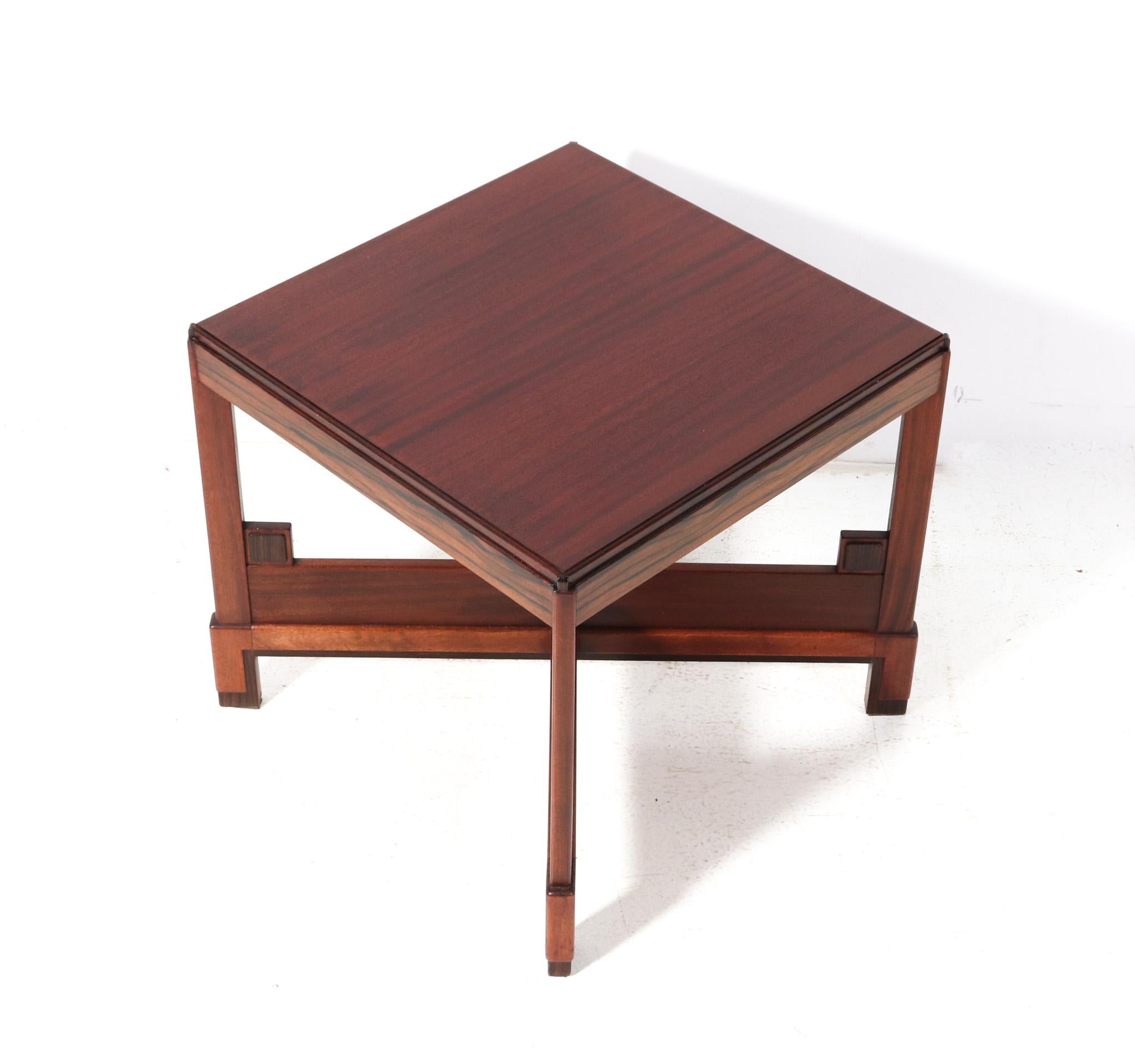 Stunning and rare Art Deco Modernist coffee table or cocktail table.
Striking Dutch design from the 1920s.
Solid walnut base with original macassar ebony elements.
The top is original veneered with walnut.
In very good original condition with minor