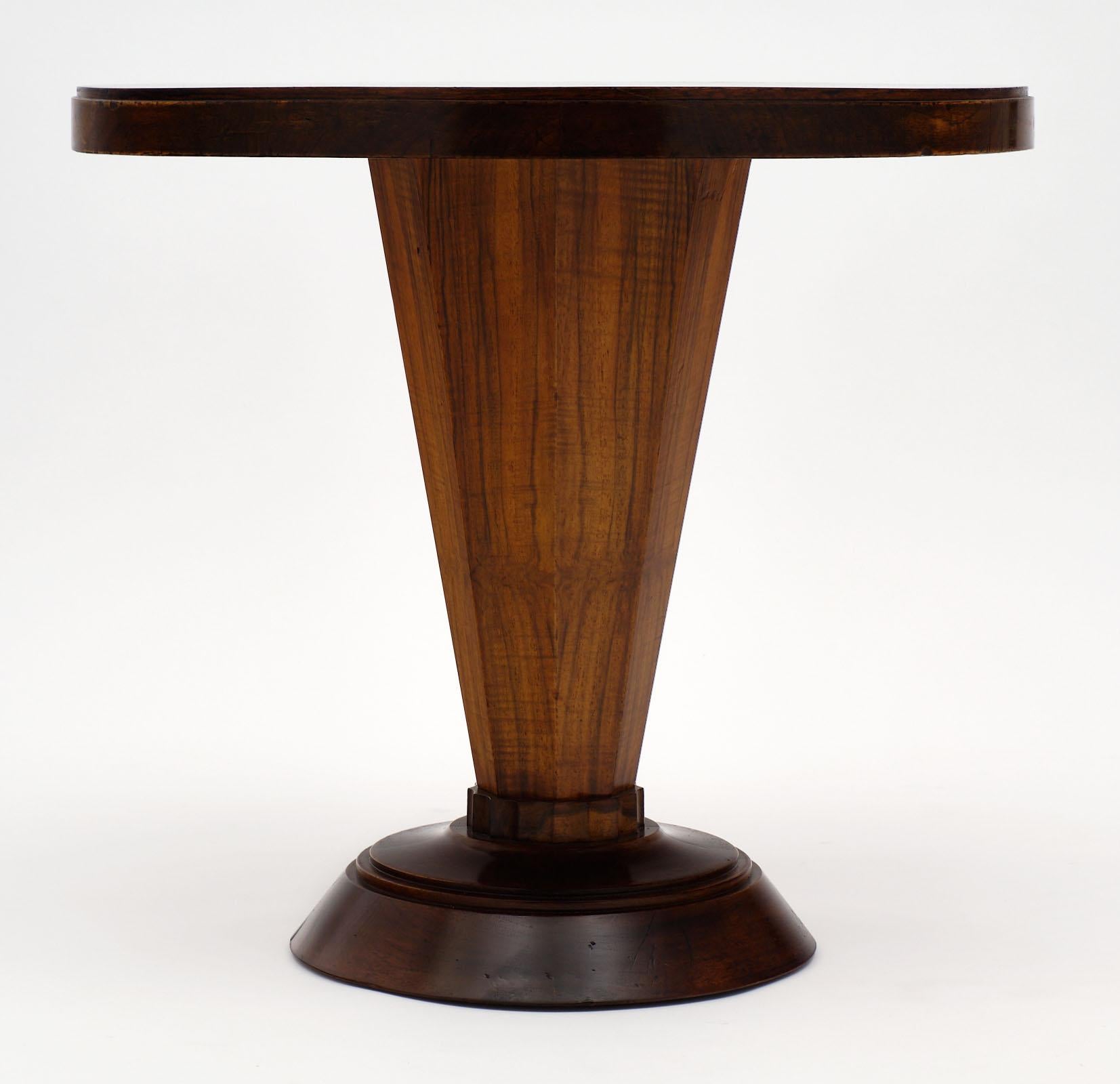 Art Deco period walnut gueridon from France. This piece is made of both solid and veneered walnut with a bold shape. We love the unique quality of this table, the lines and beautiful wood.