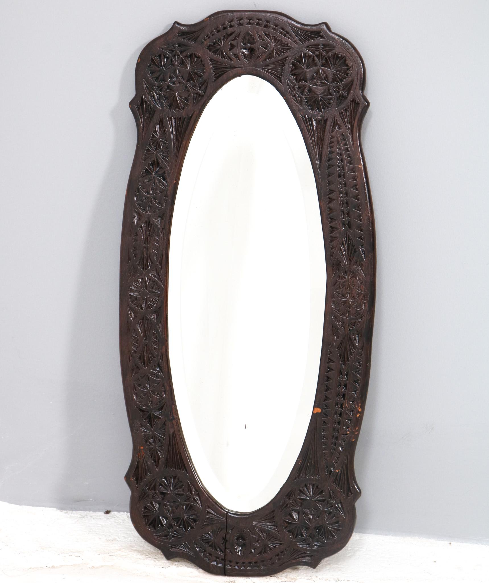 Stunning and rare Art Nouveau kerfschnitt wall mirror.
Striking Dutch design from the 1900s.
Original hand-carved walnut frame with original beveled mirror.
This wonderful Art Nouveau kerfschnitt wall mirror is in very good original condition with