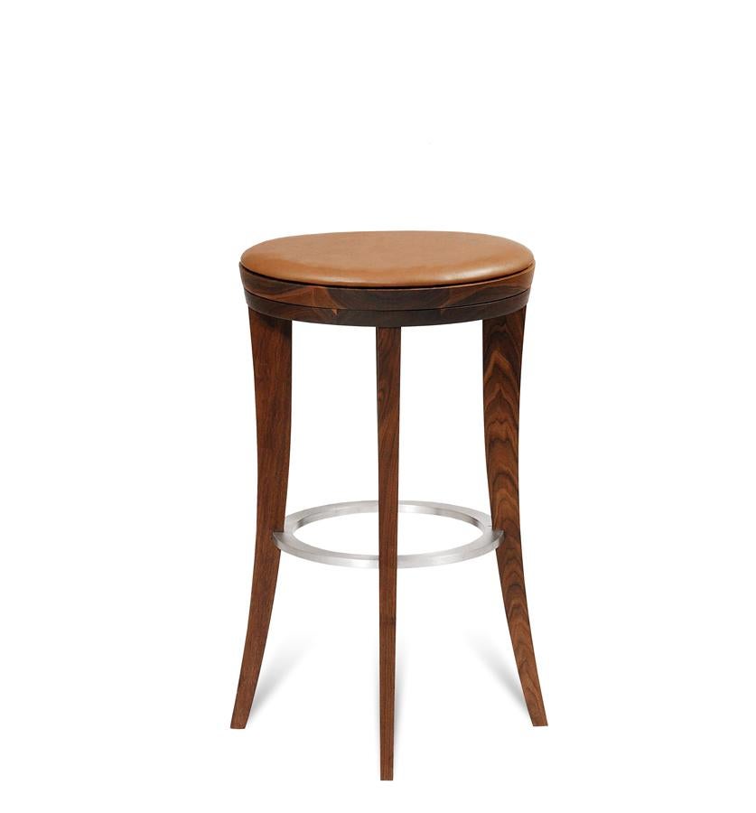 The Ava bar and counter stool is made out of natural solid walnut and features a swivel seat. The swivel allows the seat to turn and then return to its resting place which is centered on the back and front legs. The stool also has a strong back. The