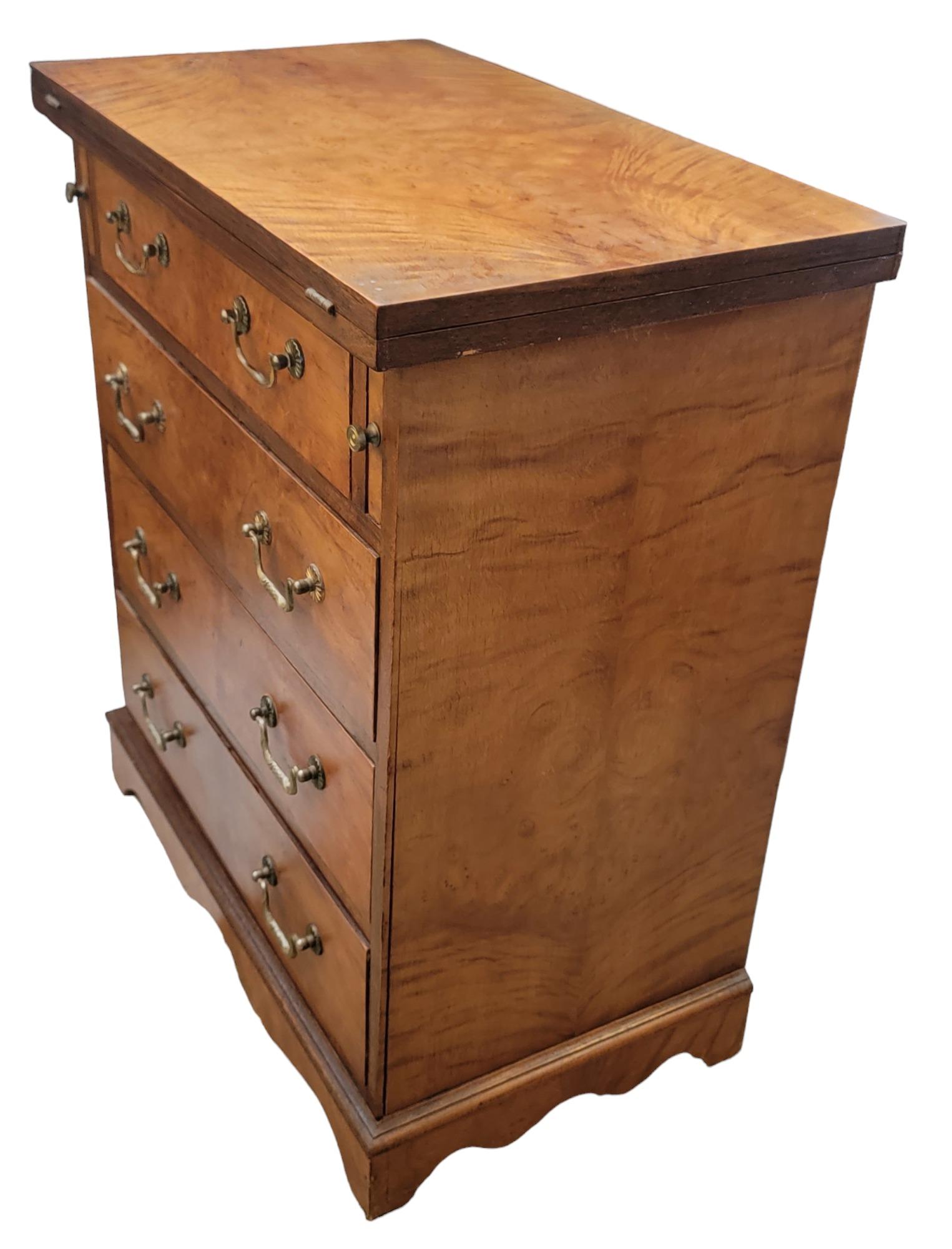 Walnut Bachelors Chest of Drawers with Brass Handles. The top opens up to make double the width. This may be used as a desk area or a sort of vanity. 

Wonderful Aged wood. Clean and polished. Great wood rings. Measures 24.75 x 14.75 x 28.75

