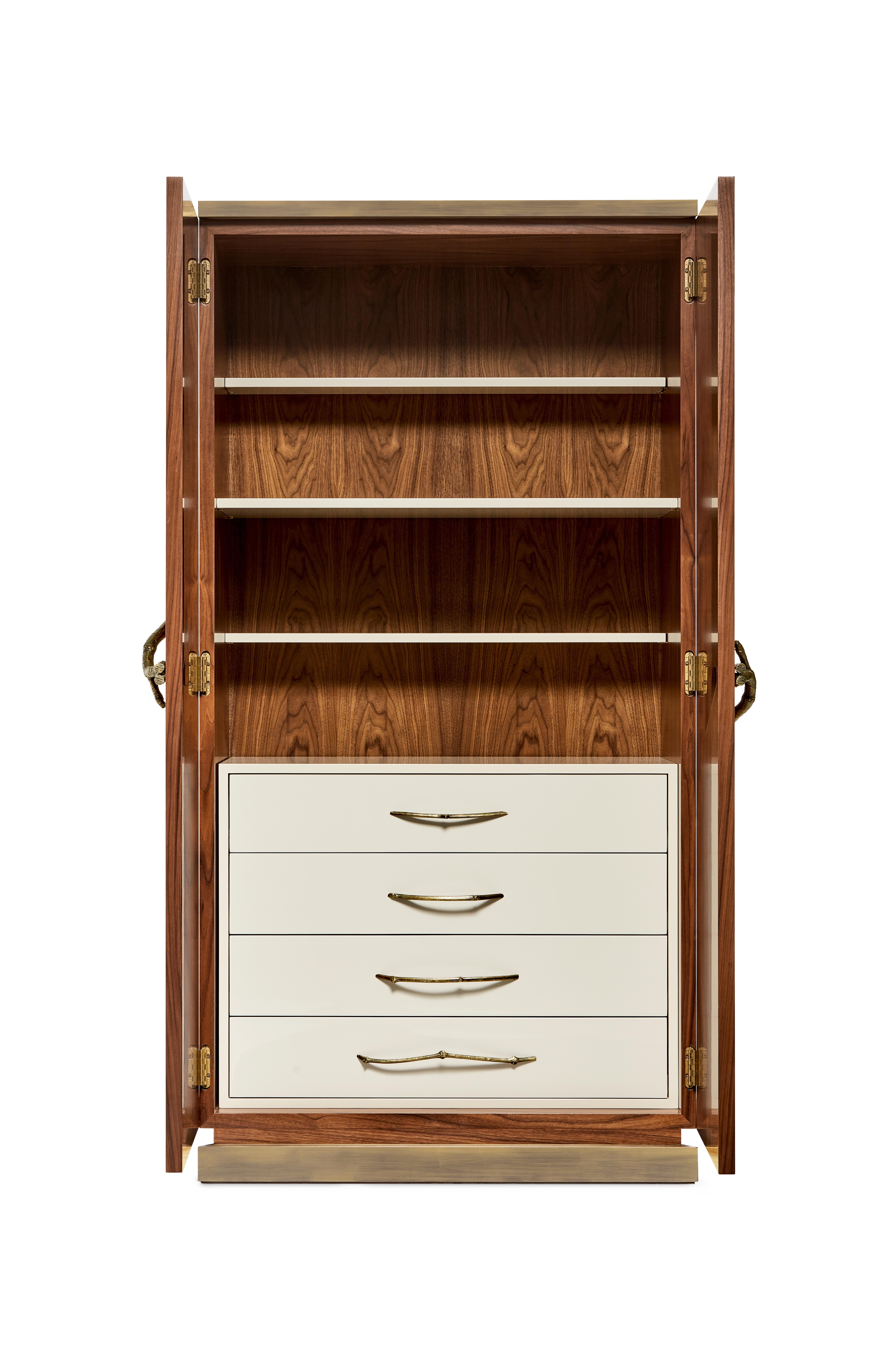 Mobile bar in noce di Ginger & Jagger
Dimensioni: P 56 x L 100 x H 196 cm. 
Materiali: Noce americano, ottone e lacca.
Finiture: Ante impiallacciate in Noce Americano opaco; cassetti e ripiani laccati lucidi Stone; maniglie in fusione di Ottone con