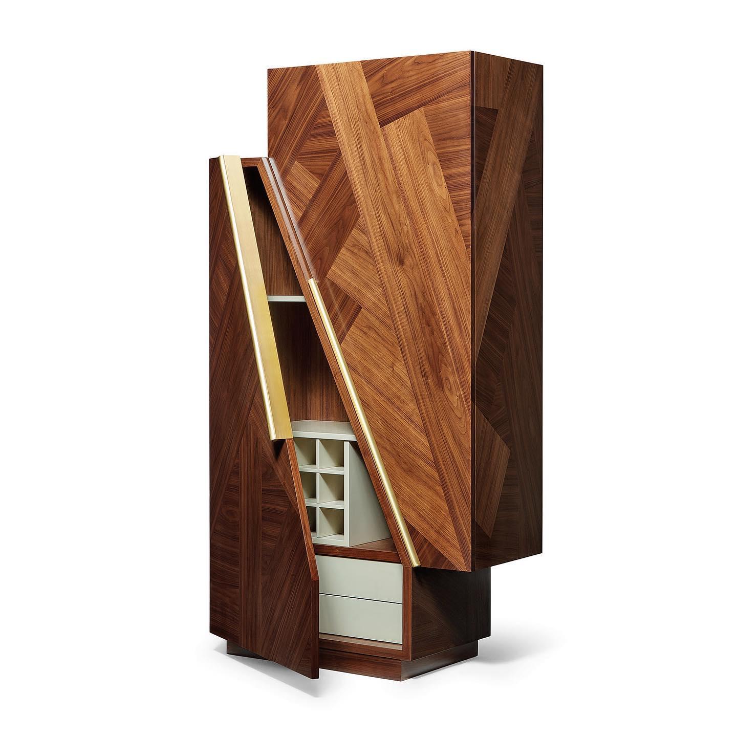 This bar Cabinet is a contemplation on the polarities in Nature. The wood marquetry is the framing device for two large doors, with an interior designed and made to hold glasses and bottles.
Body: American Walnut.
Drawers , shelves and wine rack :