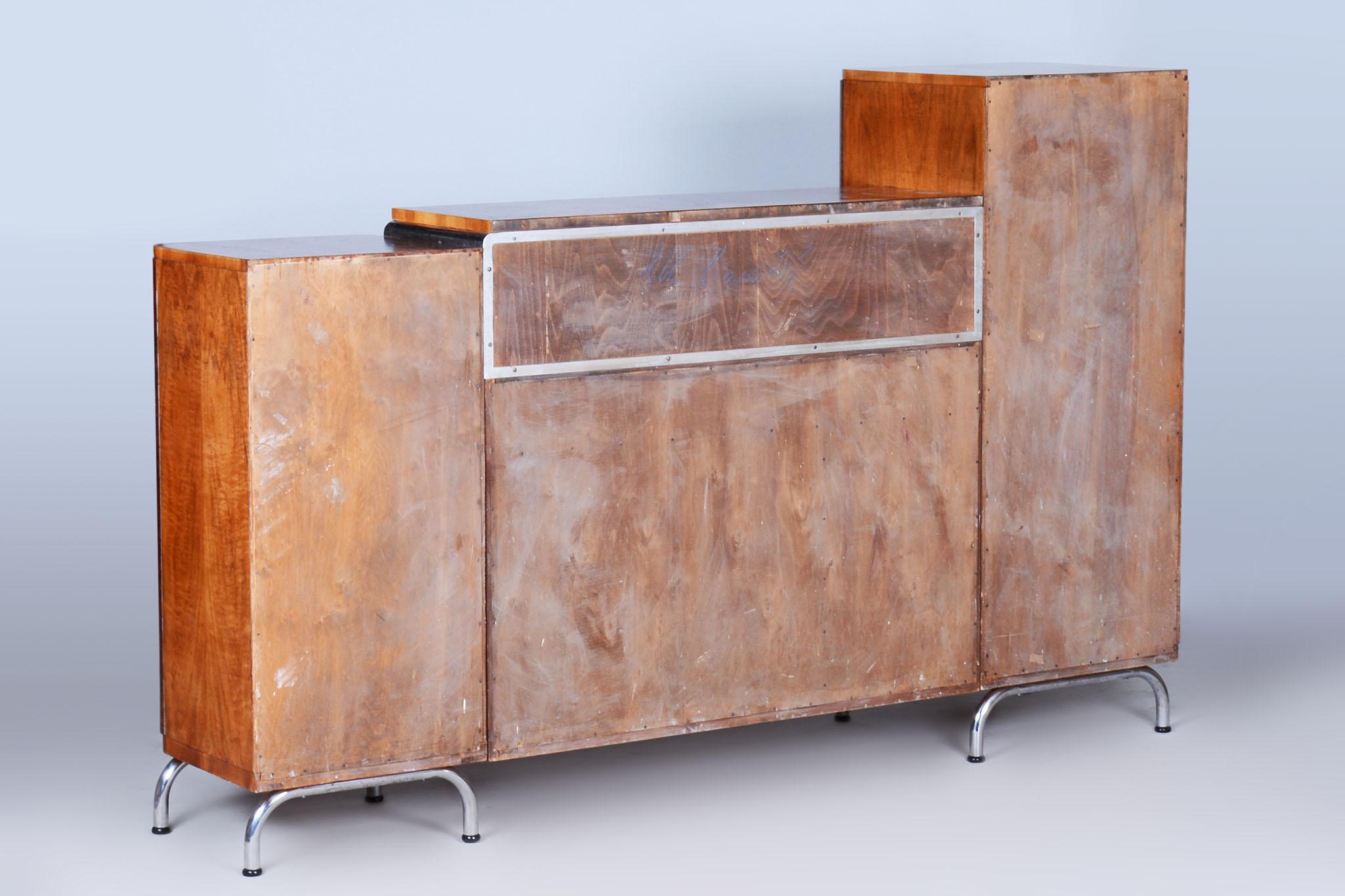 Walnut Bauhaus sideboard by Robert Slezak. 

Source: Czechia (Czechoslovakia)
Period: 1930-1939
Material: Chrome-Plated Steel, Walnut, Glass
Number of drawers: 3

Revived polish.
The chrome parts have been cleaned and professionally