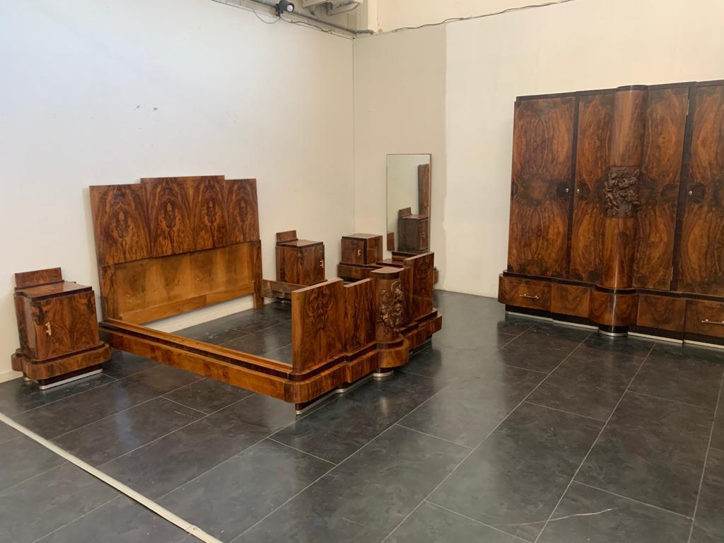 Art Deco bedroom probably made by the Ducrot firm of Palermo.
The wood is walnut selection, the lines are wavy. 
The bed on the front presents a triumph of putti playing, finely carved. The bed is solid with three-level sides of generous size, which