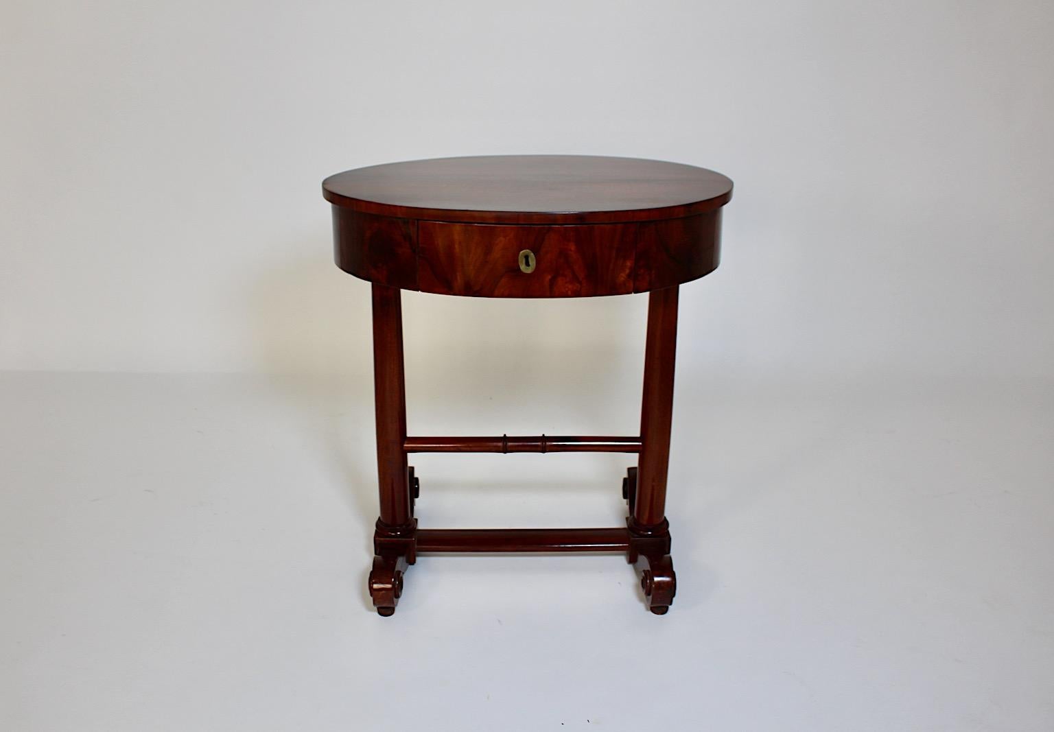 Biedermeier vintage side table or sewing table oval like from maple and walnut circa 1825 Vienna.
An elegant authentic Biedermeier side table or sewing table in oval like form from maple and walnut with beautiful details like one lockable drawer