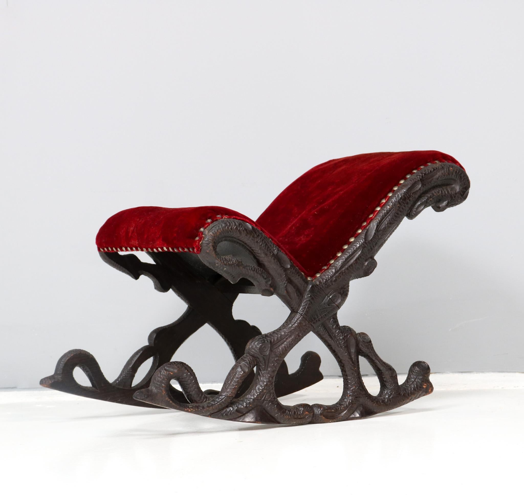 Magnificent and ultra rare Black Forest footstool. Design attributed to Matthijs Horrix for the famous Dutch cabinet makers Horrix Den Haag. Striking Dutch design from the 1880s. Solid hand-carved walnut base and re-upholstered with a quality velvet