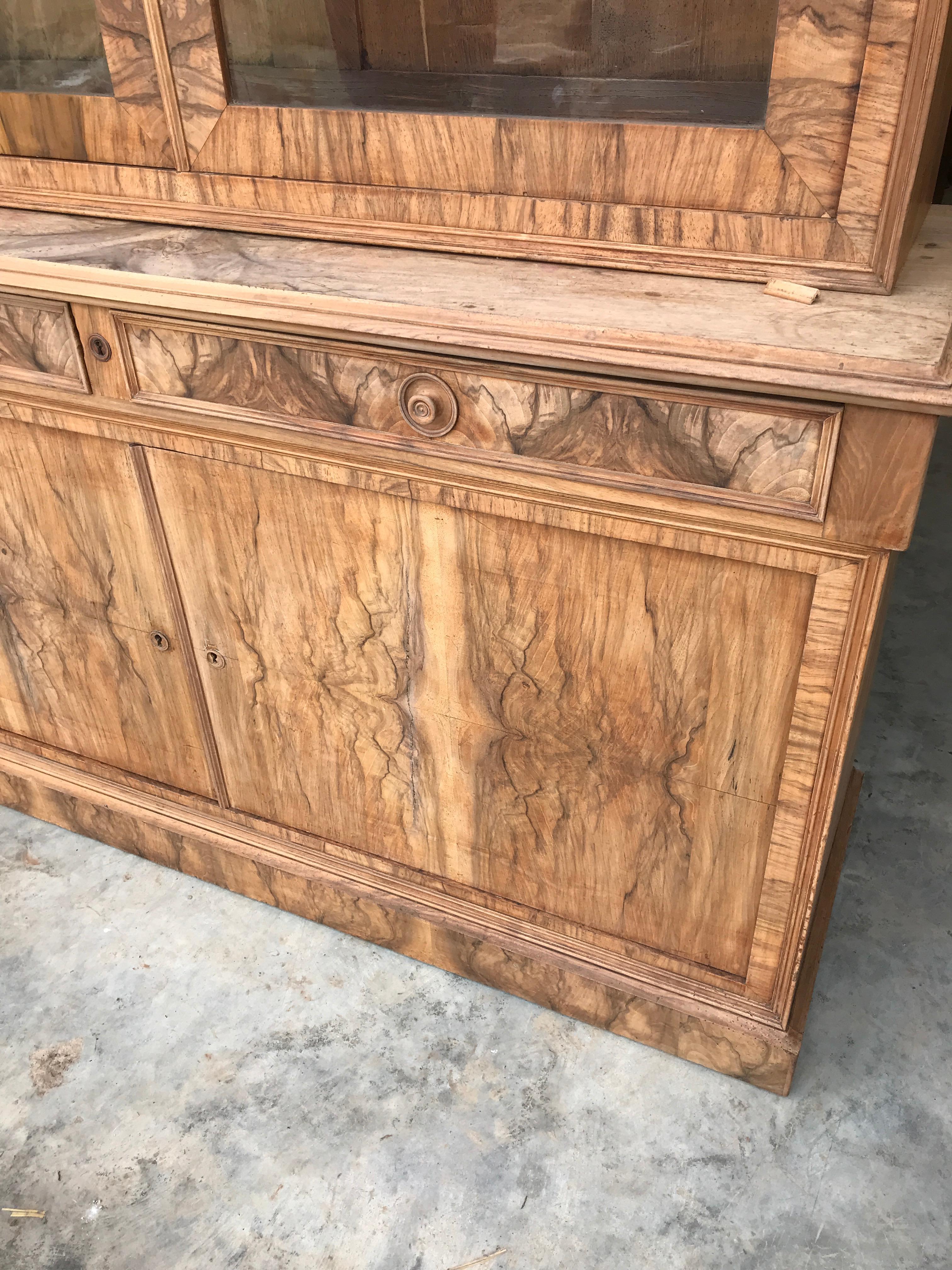 A wonderful burr walnut bookcase just fantastic figuring on the timber and has its very nice original glass. We have taken it back to a flat finish, just a very nice bookcase. It has 4 adjustable shelves to the top and one in the base.
