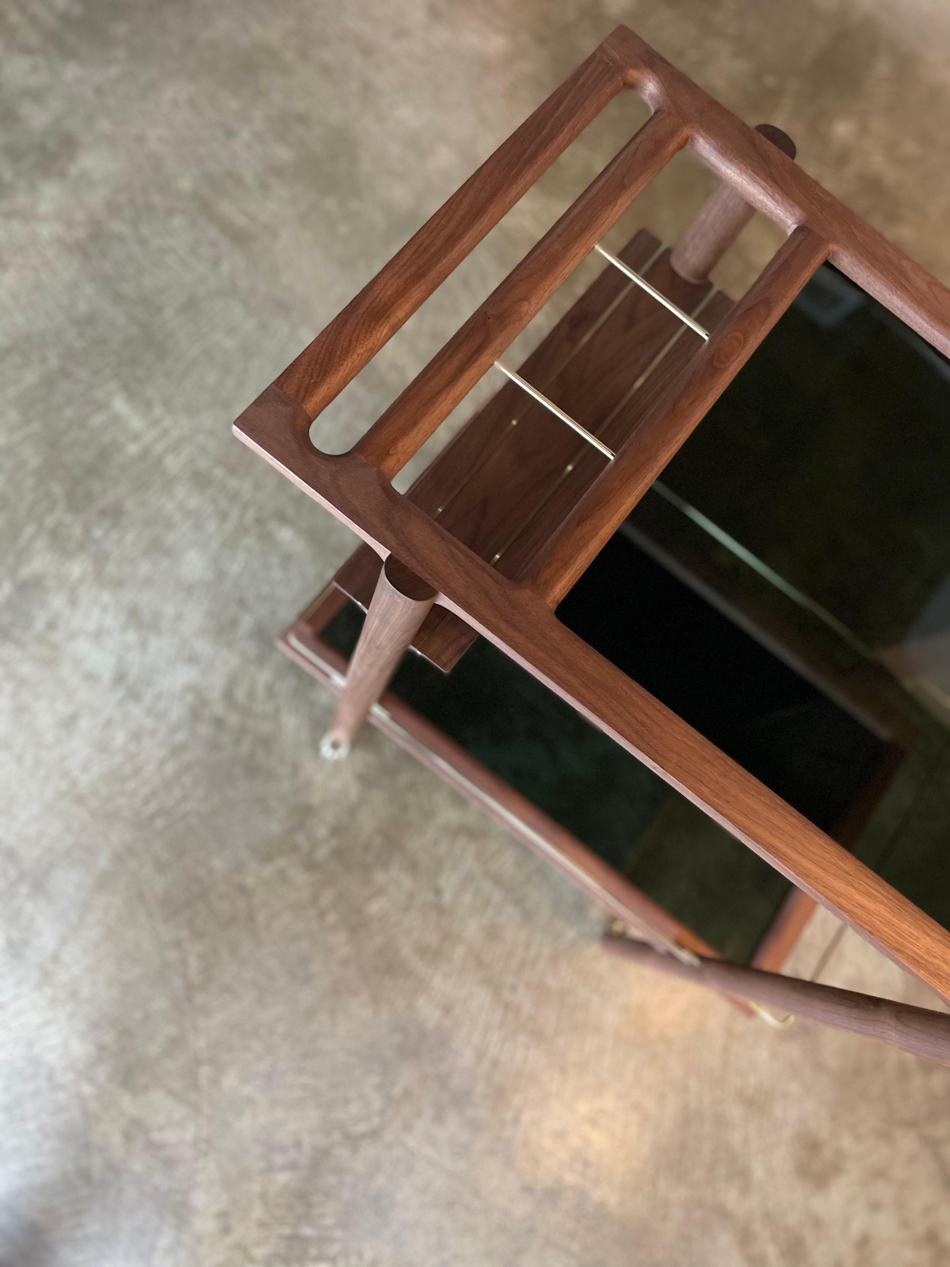Solid wood constructed barcart with hand-cut joinery, tempered glass panels, and fine metal accents. Handmade in Los Angeles, California.

Shown in walnut.
Please inquire for custom wood, metal and glass options.

Wood type is available in ebonized
