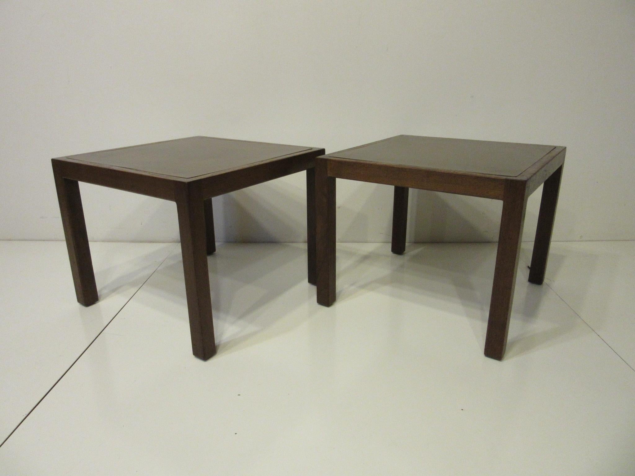 A parsons styled walnut framed set of side tables with veneer acid etched brass and clear coated  inserted tops . Simple and well crafted locally known in the Seattle area as Northwest Contemporary they till retain the original manufactured labels