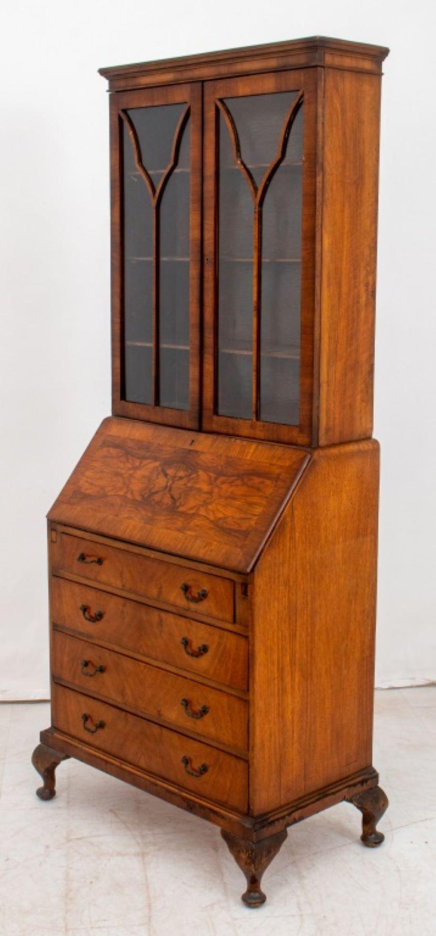 Walnut Bureau Bookcase, twentieth century, with two door cabinet with three shelves above slanted fall front secretary with divided and fitted interior over four frieze drawers on four ball feet, labeled 
