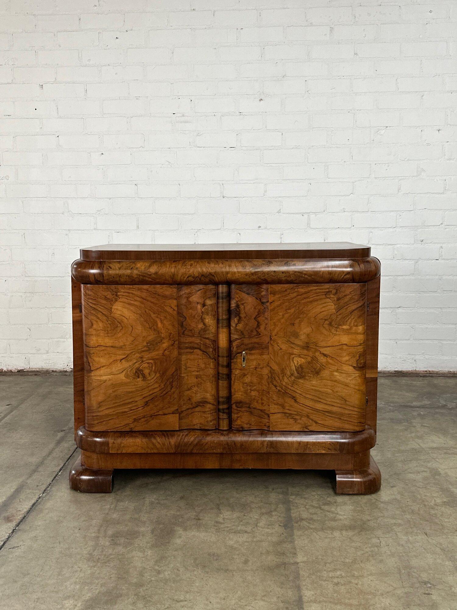 W45 D22 H35.5

Fully restored flamed walnut burl wood credenza in great condition. Item has been strucutrally reinfroced on interrior and exterior, credenza is now strong and sturdy. Item has been fully refinshed and shows well with no major areas