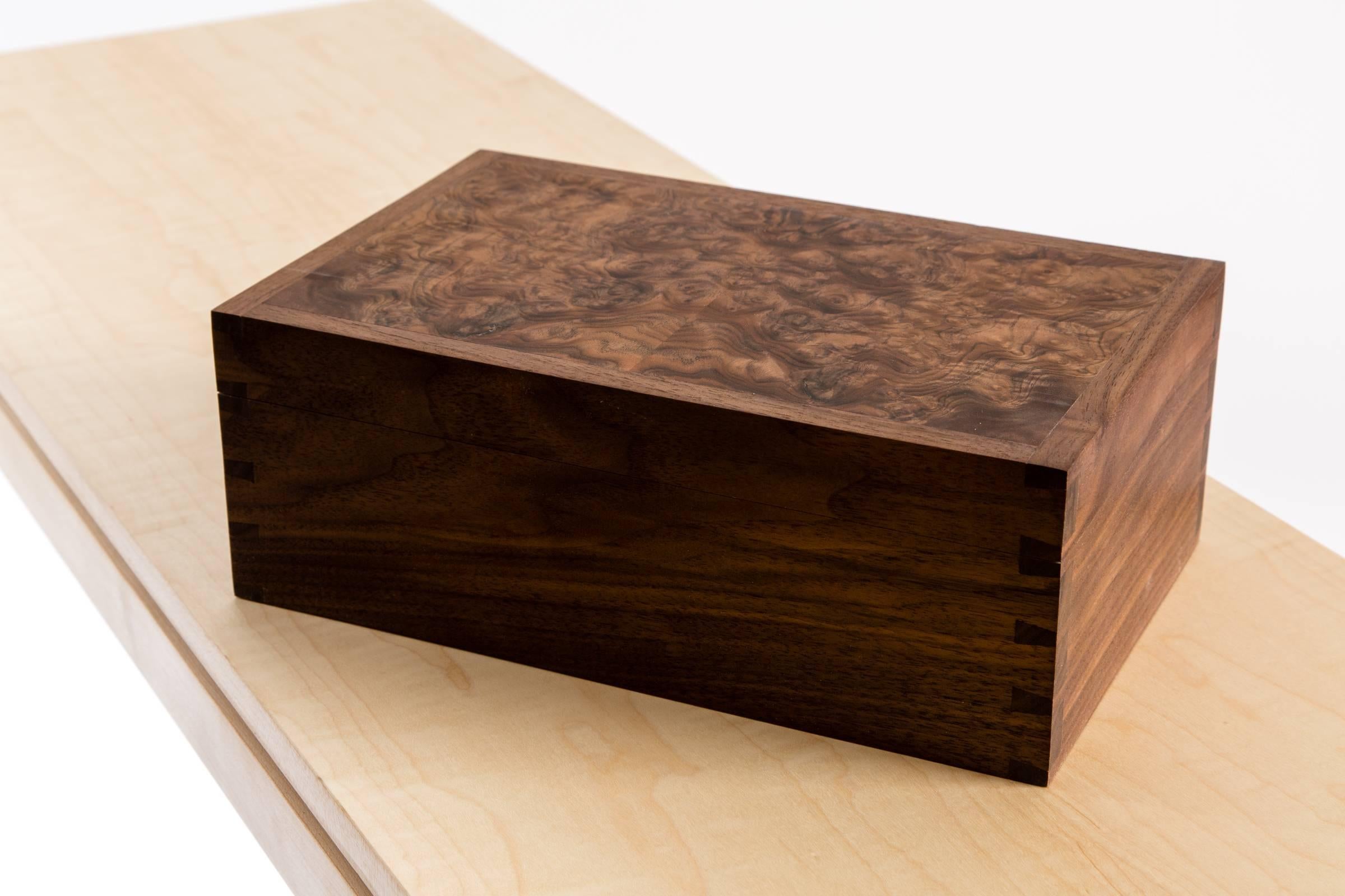 A walnut, burr walnut and maple dovetailed jewelry box.

All my work is finished by hand using traditional methods and tools. This means that it is always individual, unique and bears the imprint of the maker’s hands.
