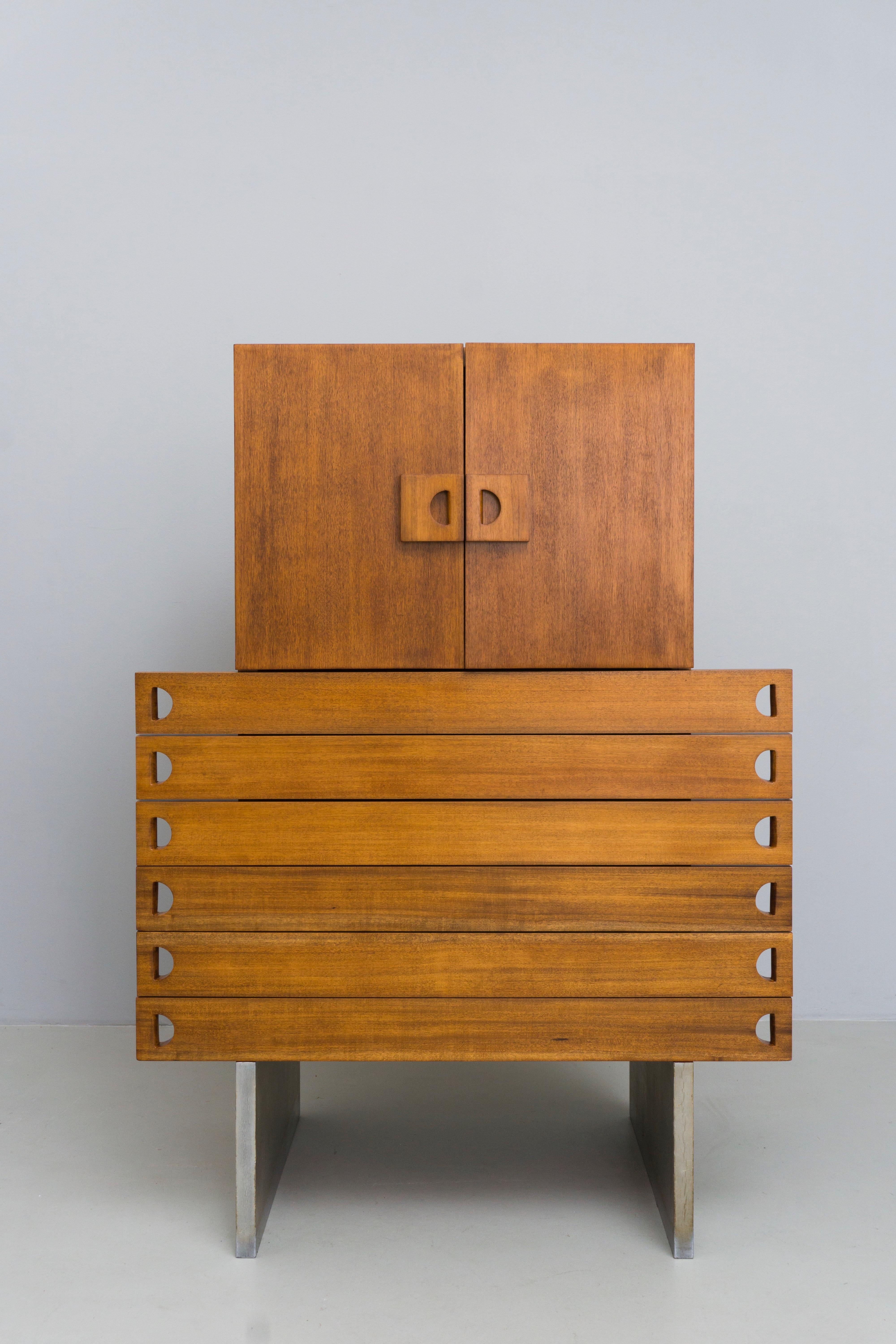 Extremely rare walnut cabinet by an unknown designer. This mysterious and unique piece is made of walnut wood with silver covered sides. Upper part with two doors and inner shelves. Lower part with 6 drawers.

 