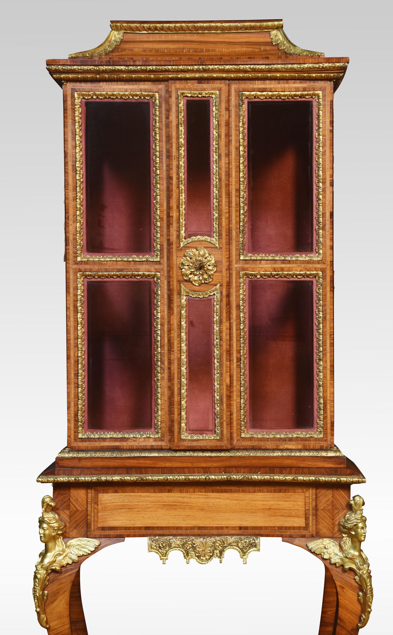 Kingwood collectors cabinet on stands the moulded pagoda-style top above bevelled glazed doors opening to reveal a velvet-lined interior and single glass shelf. The base section fitted with freeze drawer raised on four slender cabriole supports