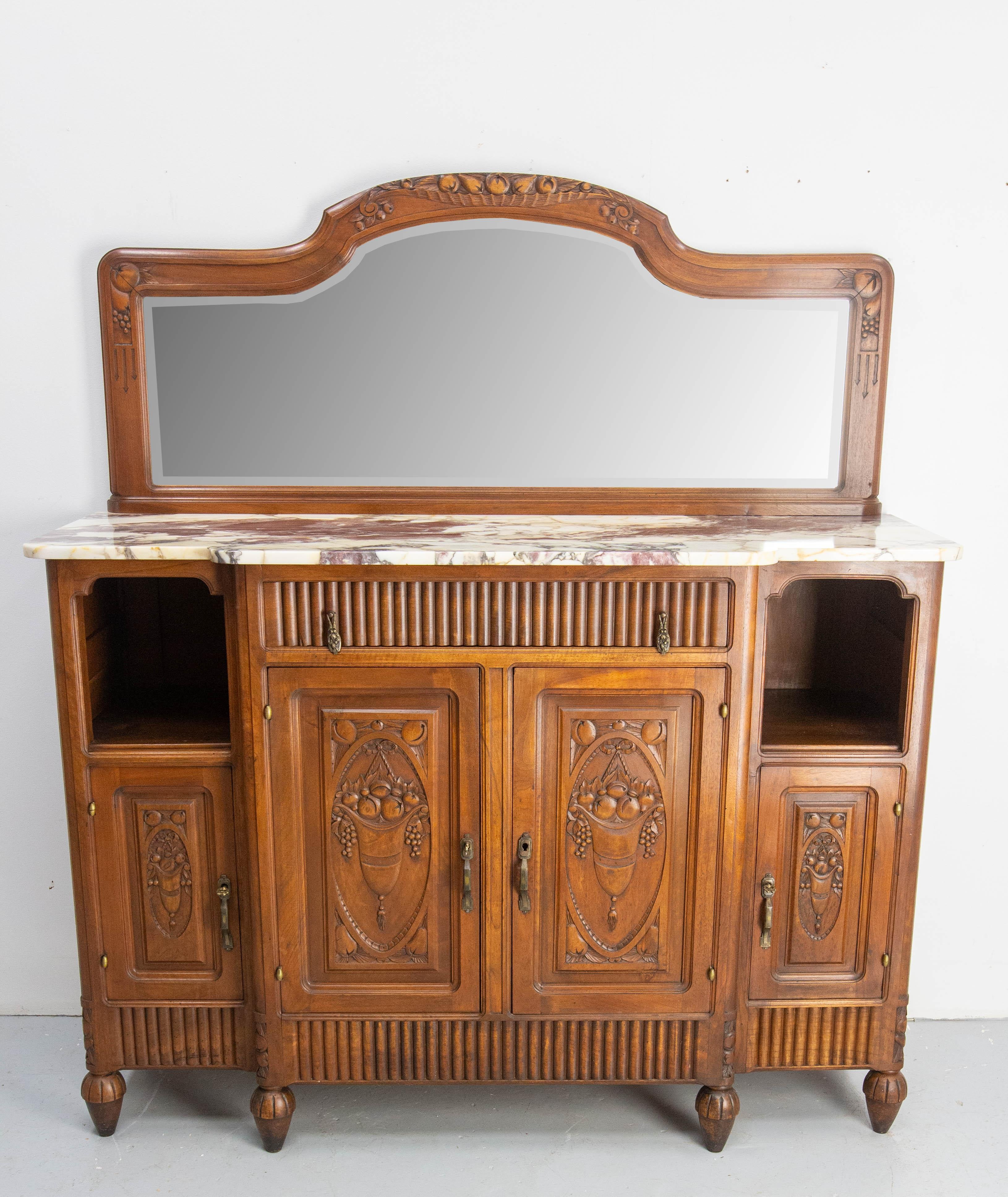 French credenza mirror buffet made circa 1920.
Walnut and caracatta marble white and violet with yellow marbling.
One drawer, four doors and two niches.
Height of the marble top: 40.17 in. (102 cm)
The mirror is beveled.
The doors are hand caved