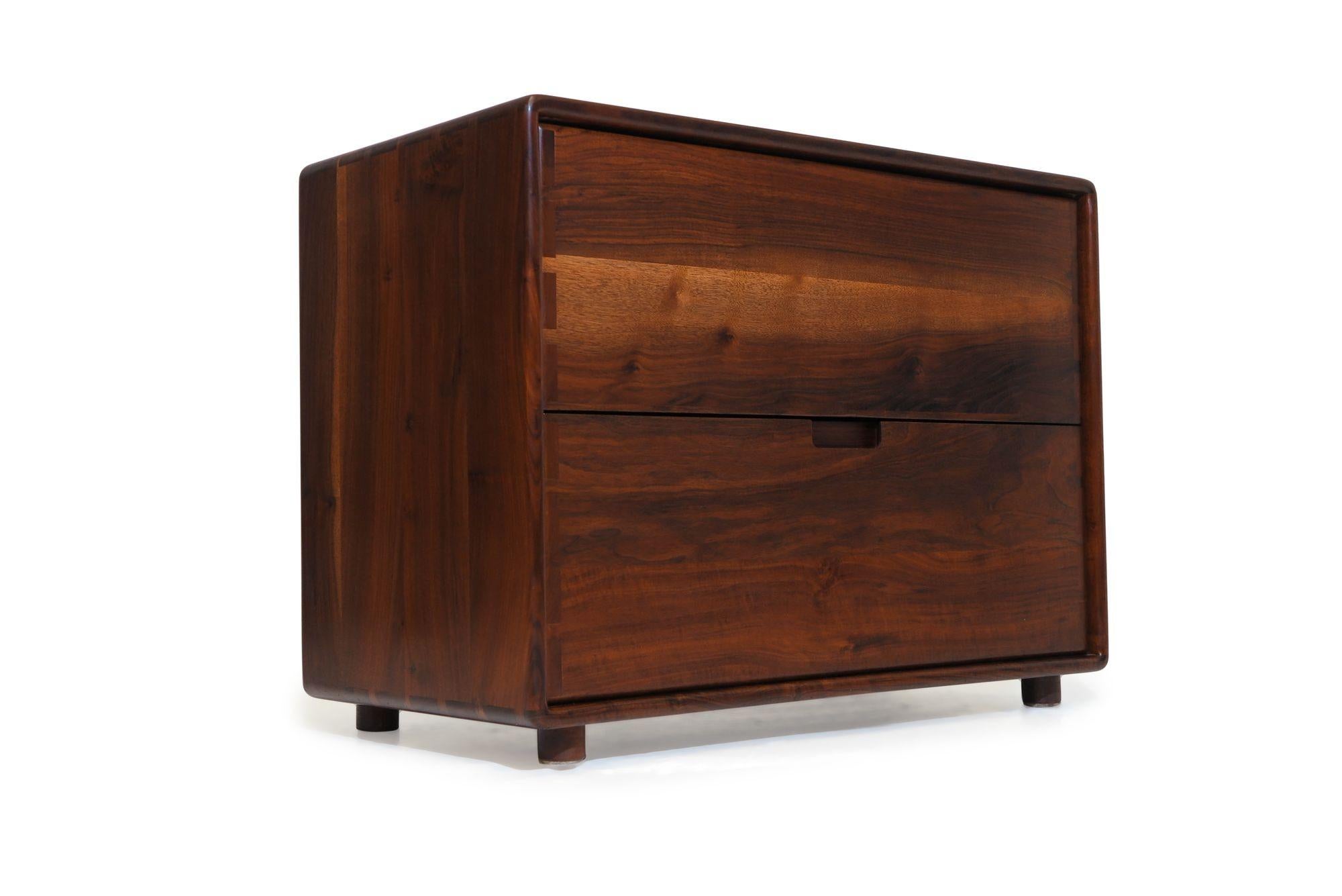 California studio craft filing cabinet designed by Jim Sweeney, Berkeley, circa 1983. The cabinet is handcrafted of solid black walnut, and features two filing drawers with boldly exposed joinery on the cabinet and drawers. The cabinets have been