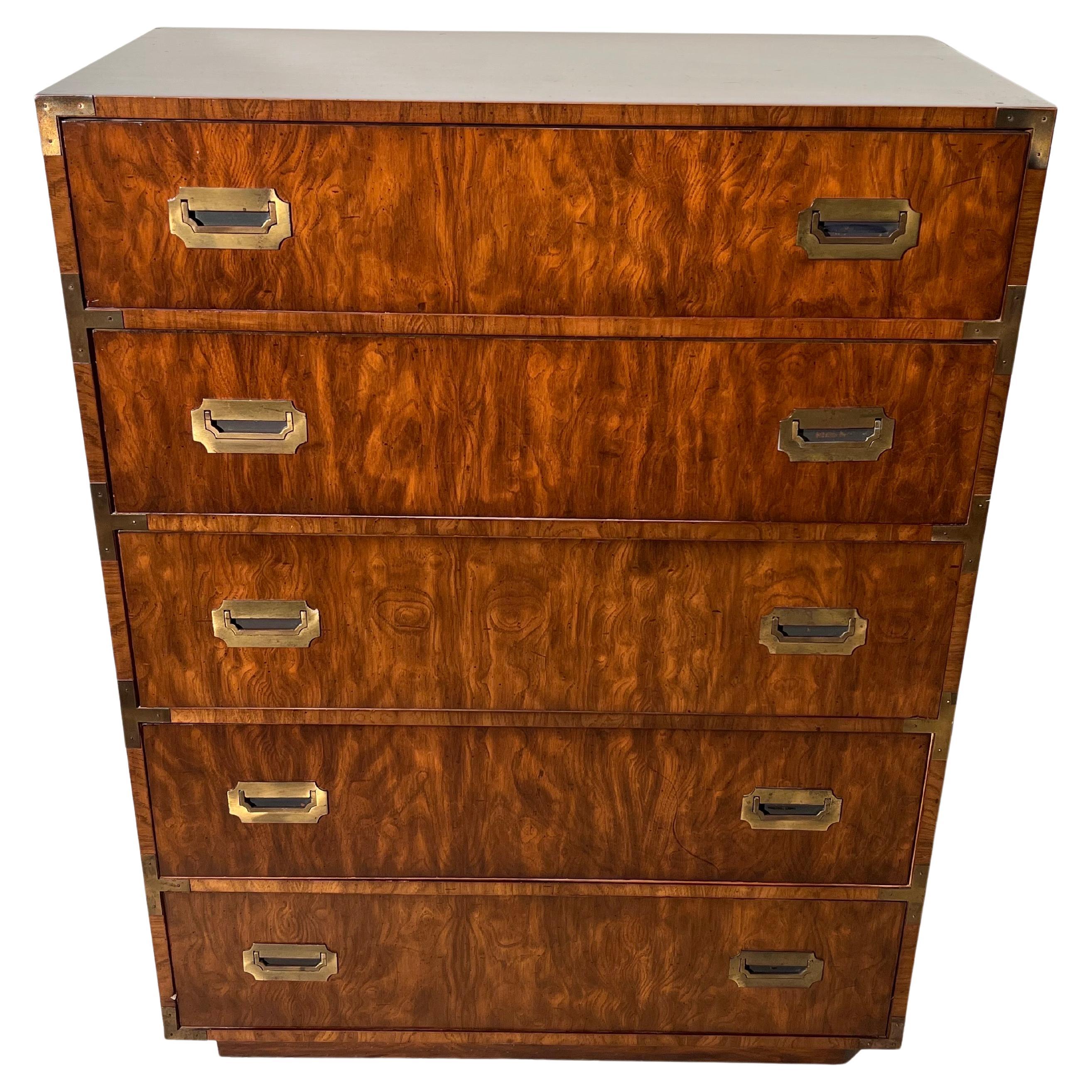 Walnut campaign dresser in the style of Henredon. Classic 5 drawer dresser with chunky recessed brass plated hardware and recessed plinth base. This Iconic 