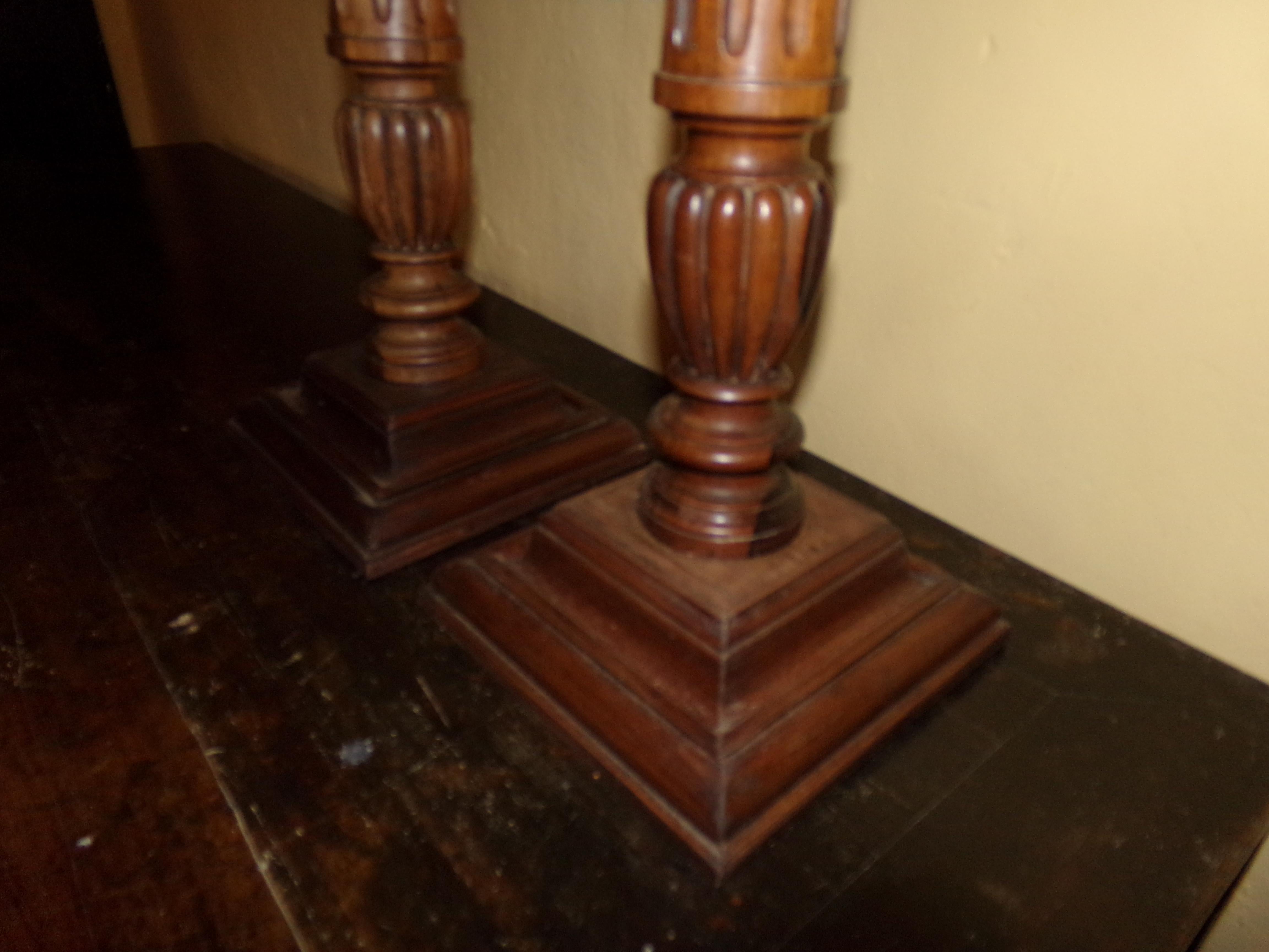 A super pair of turned and fluted hand carved pricket walnut torchiers or candlesticks in the Louis XVI style beautifully crafted from original circa 1890s wood turnings. Our craftsman has retained all the original patination. A beautiful holiday
