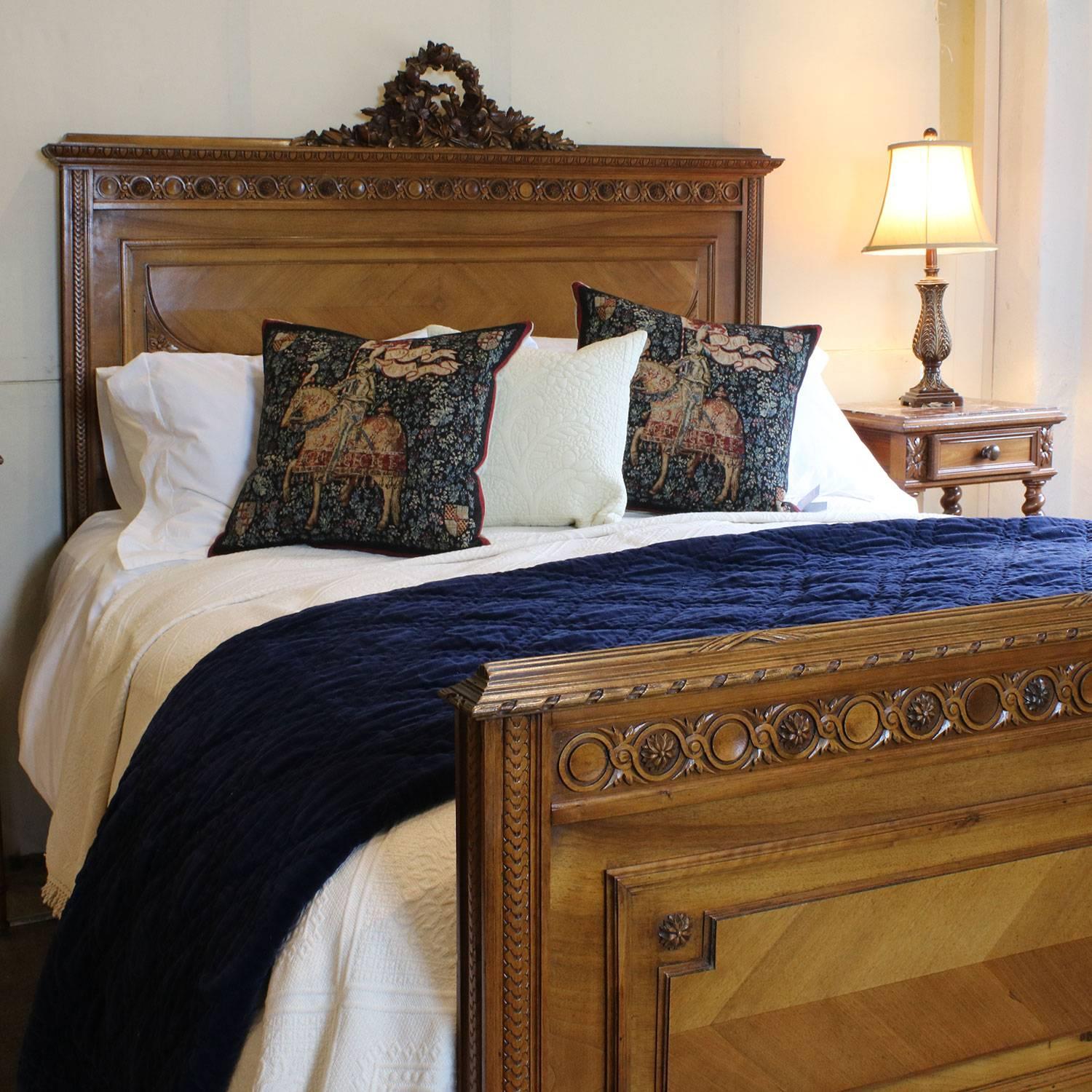 A walnut carved bed with ornate pediment on the head panel and quartered veneer panels.

This bed accepts a British king-size or American queen-size (60 in wide) base and mattress set.

The price is for the bedstead alone. The base, mattress and