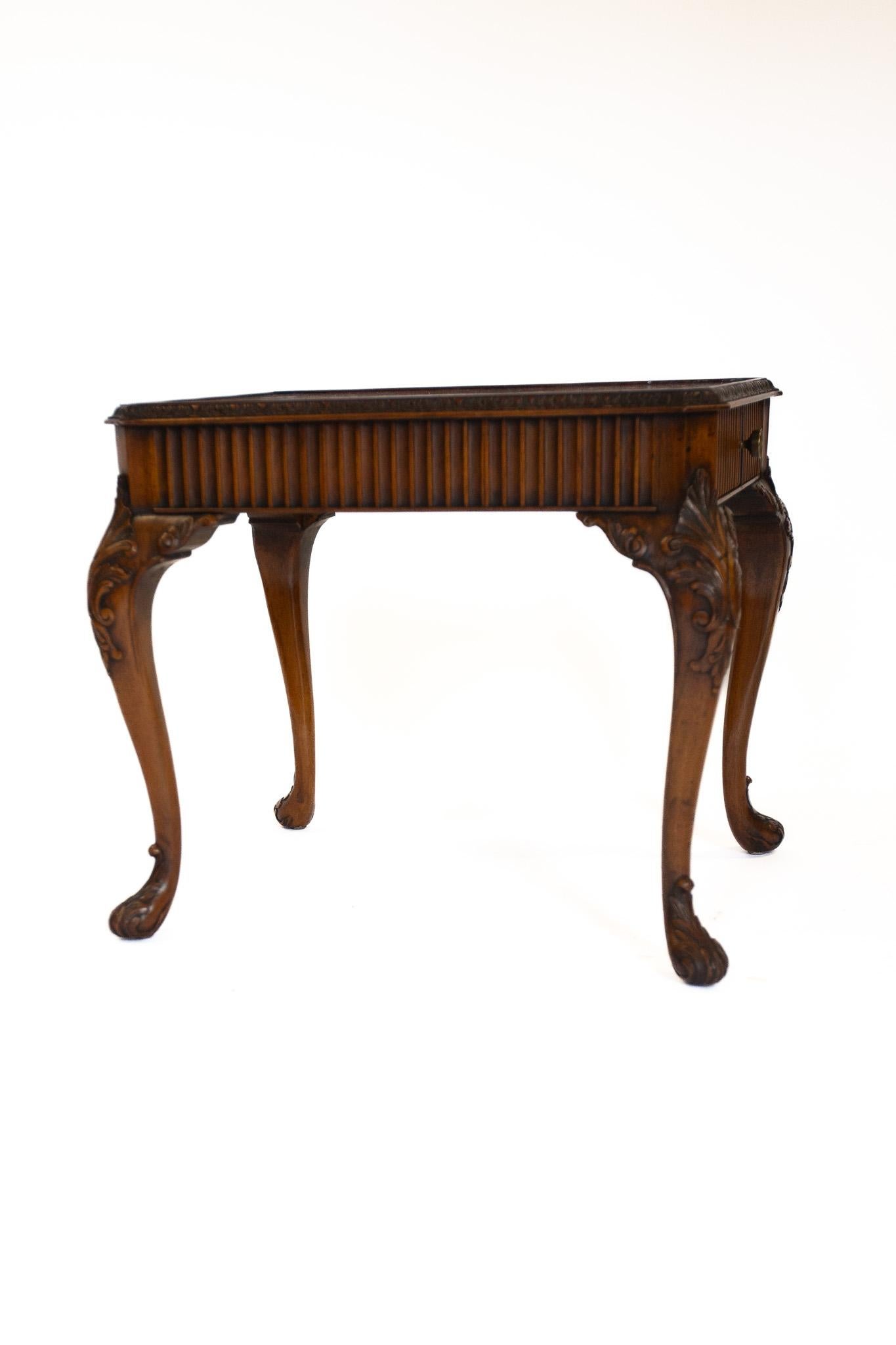 Walnut & carved coffee table with drawer circa 1930s
Rectangular in shape, 
Burr Walnut quarter veneer on top, with canted corners
and carved mould frame, 
Reeded carved detail around frieze, with drawer at one end, 
Sitting on 4 carved cabriole