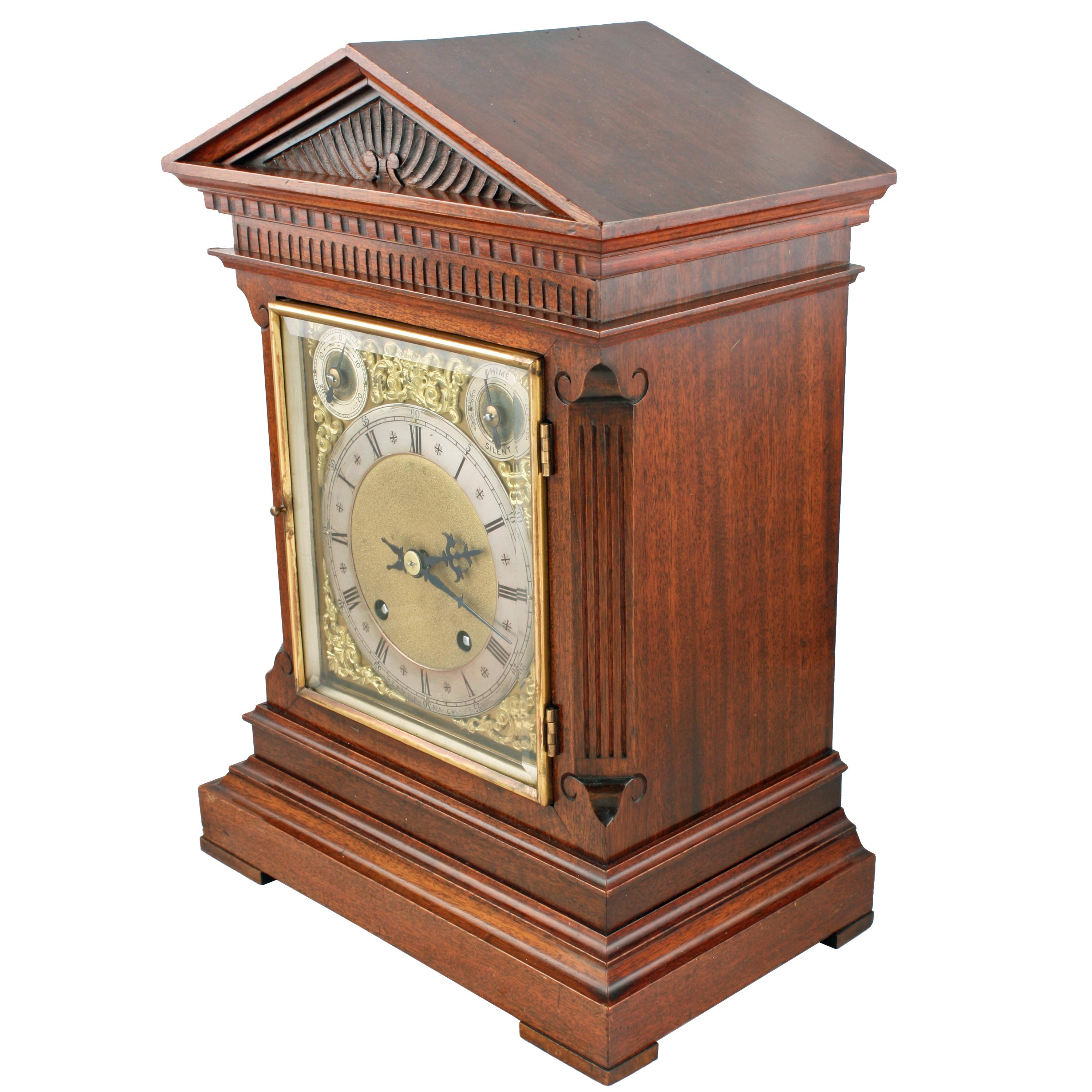 A late 19th-early 20th century walnut cased mantel clock.

The clock has an eight day movement works that are stamped 