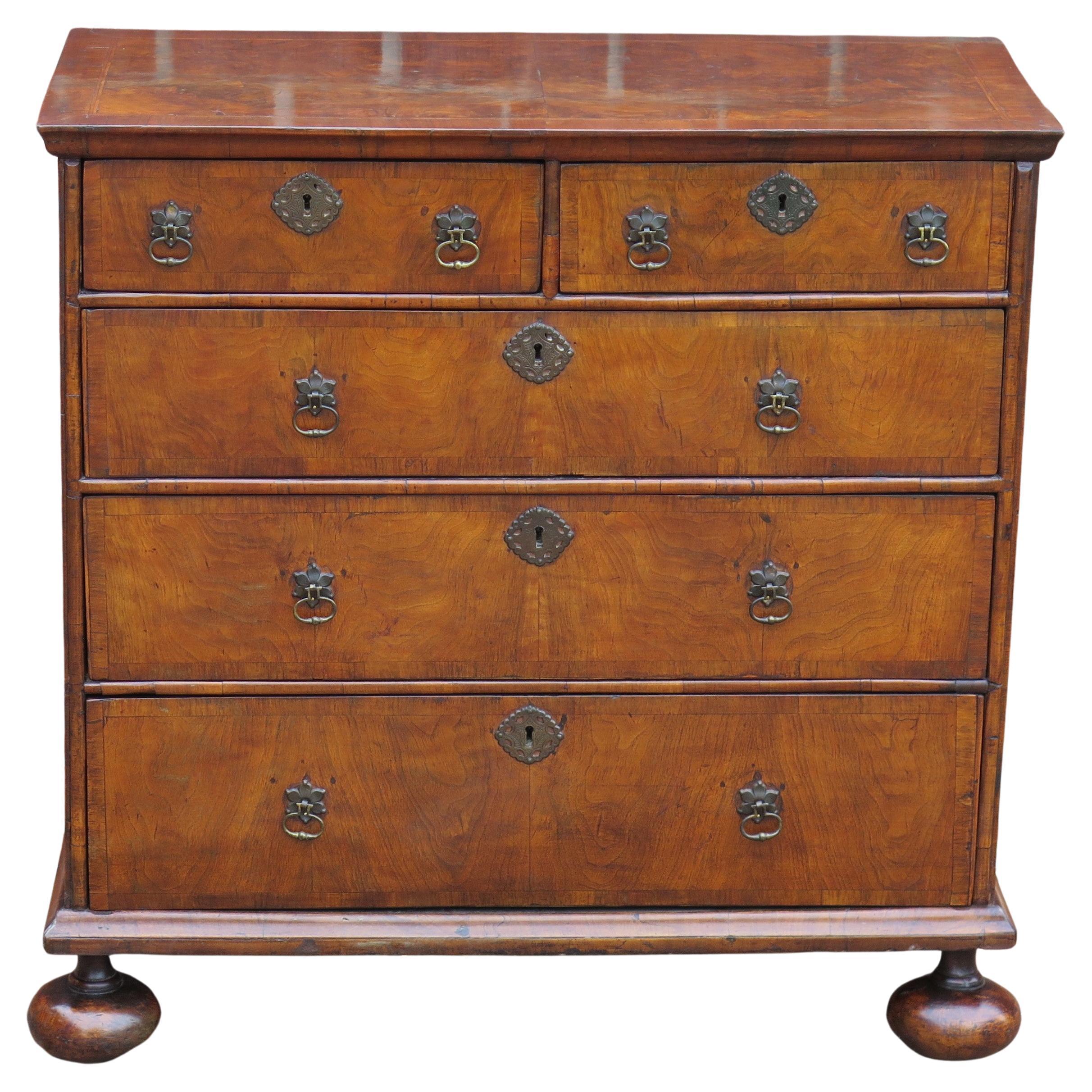 This is a very beautiful Queen Anne period Walnut Chest, circa 1690 to 1700

The Chest has two short over three long graduated drawers with matching thick cross-grained thumb mouldings to the top and lower edge of the chest at the front and sides.