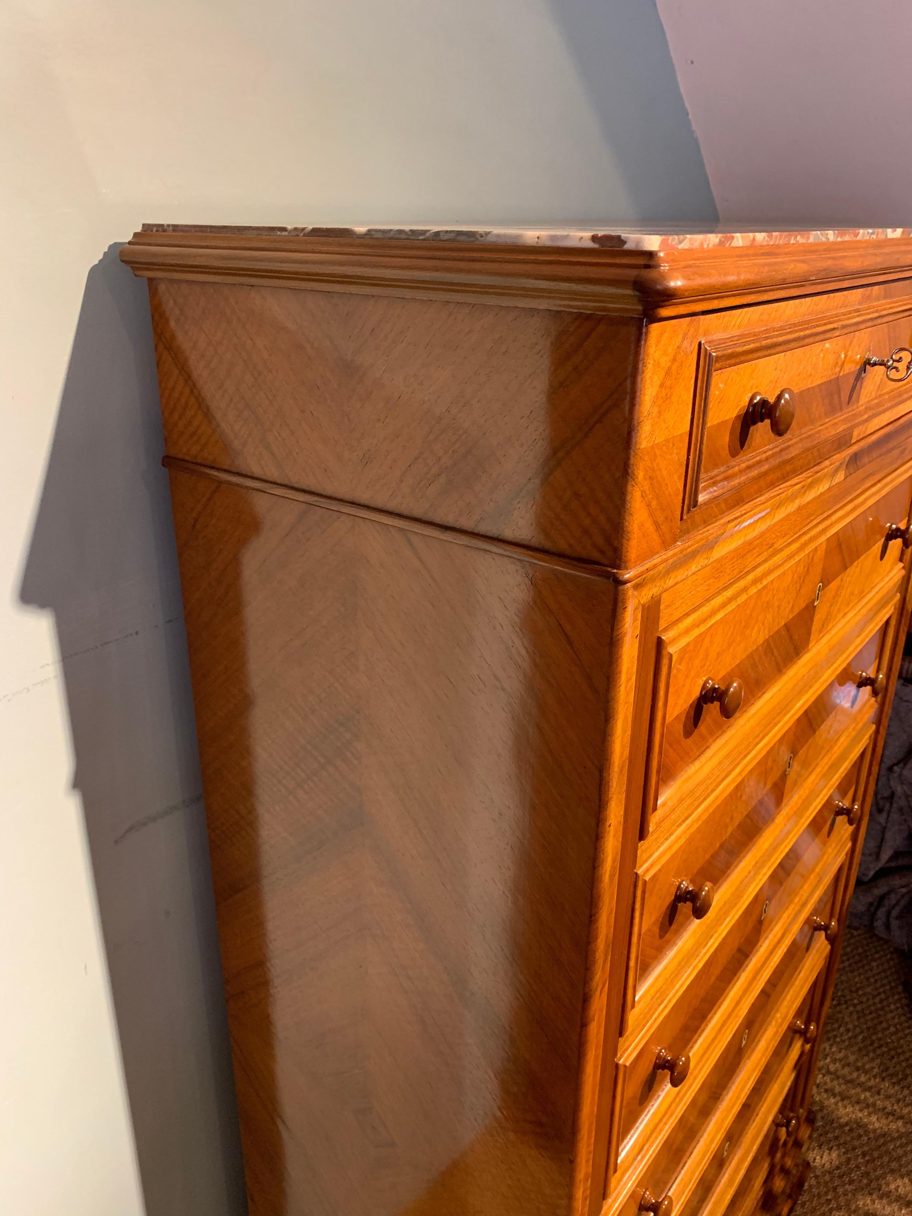Tall narrow walnut chest of drawers 

Dating to circa 1880s , having original marble top , working locks ( 1 key ) the walnut veneer laid over a solid oak carcass. 

This piece has been through our workshops been cleaned and polished and is