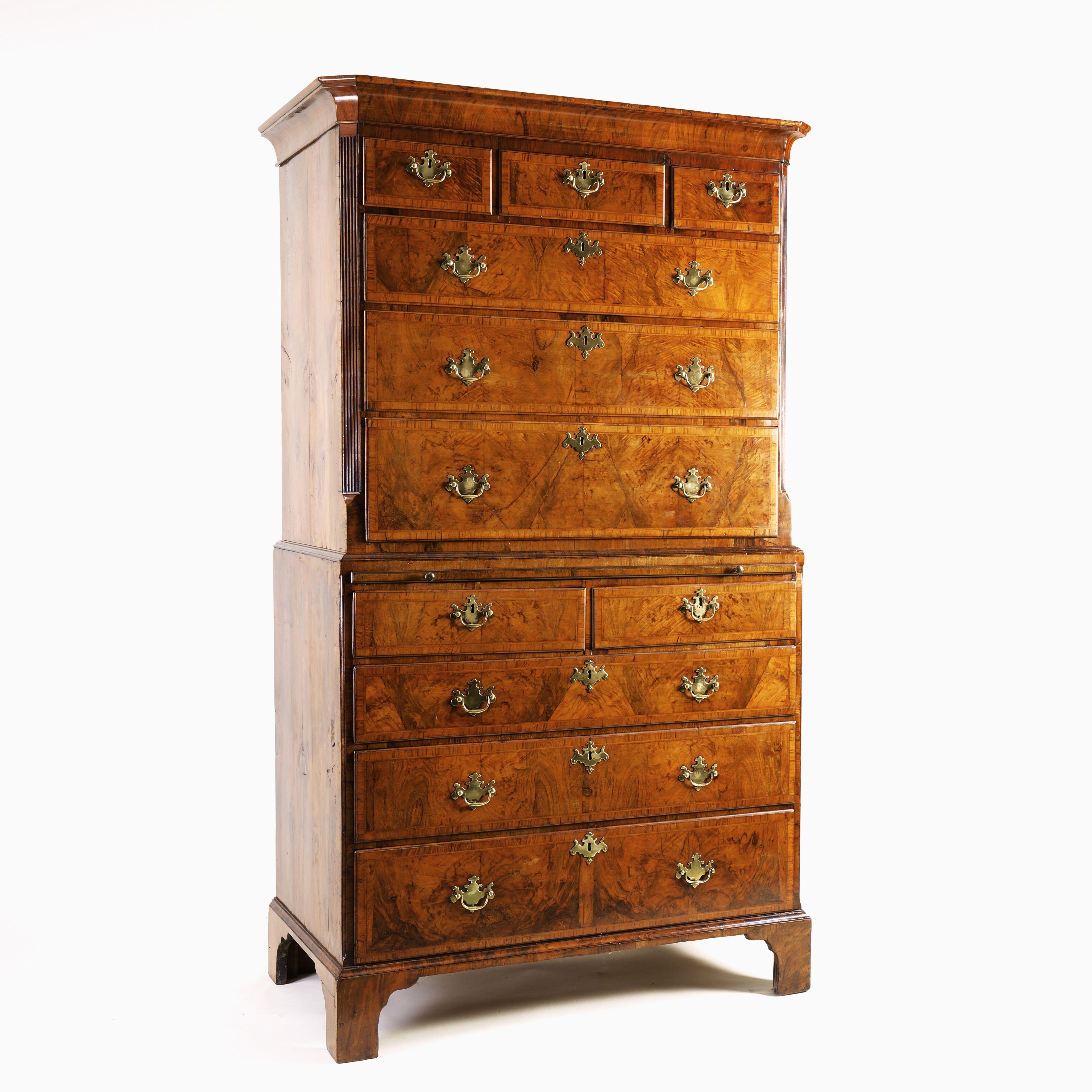 A very fine and grand example of an early 18th century walnut tallboy. The cavetto cornice above an arrangement of three short and three long drawers to the top half, which are flanked by fluted, canted corners, above the base with a brushing slide
