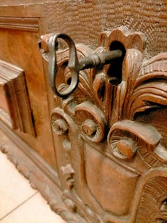 Walnut chest with maple inlays and carved friezes, from the 1600s.