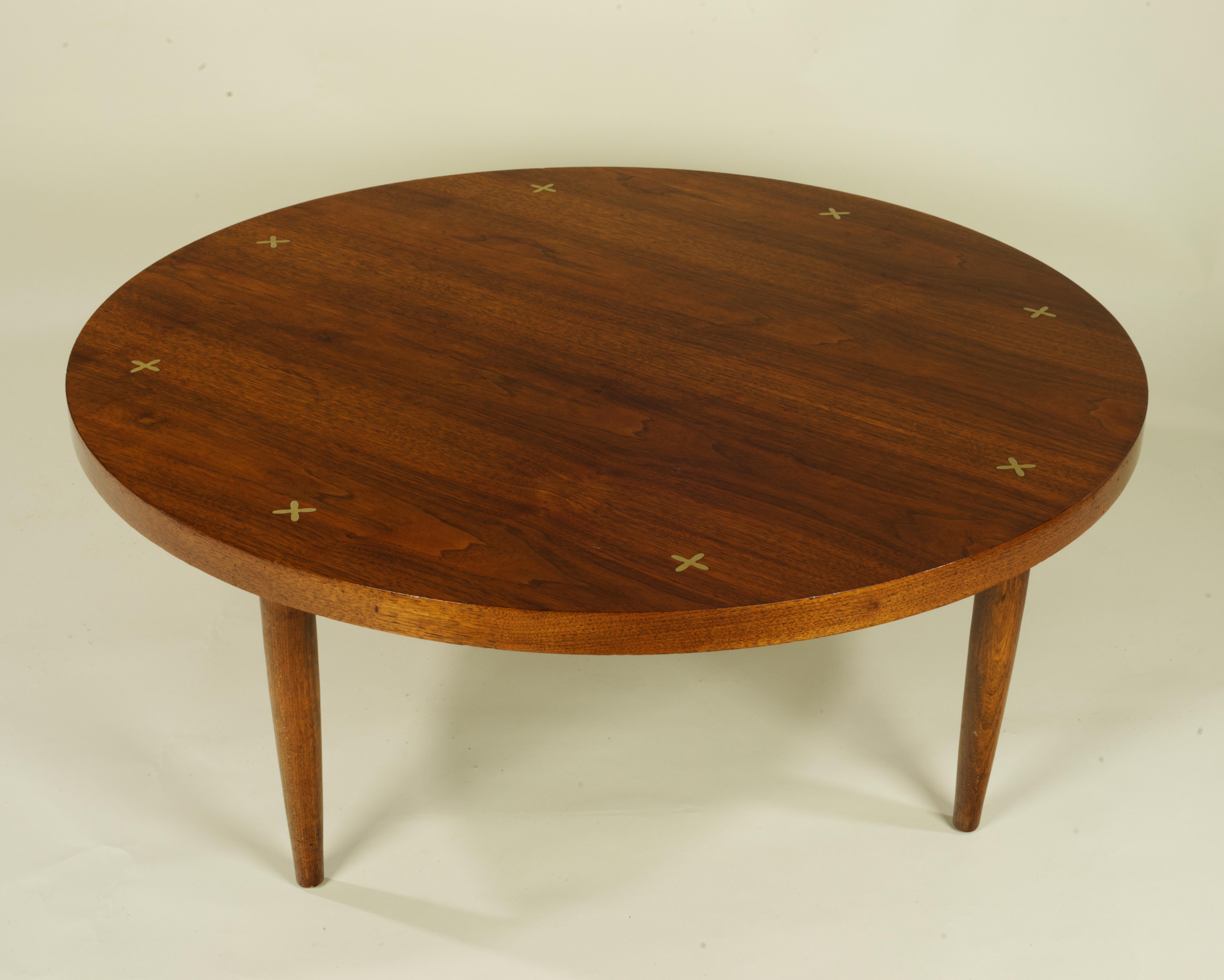 Lovely Walnut veneered coffee table, designed by Merton Gershun and manufactured by American of Martinsville. Selection of the Walnut veneer and book matching are superb. 
There are no structural issues with he table. Over all condition is