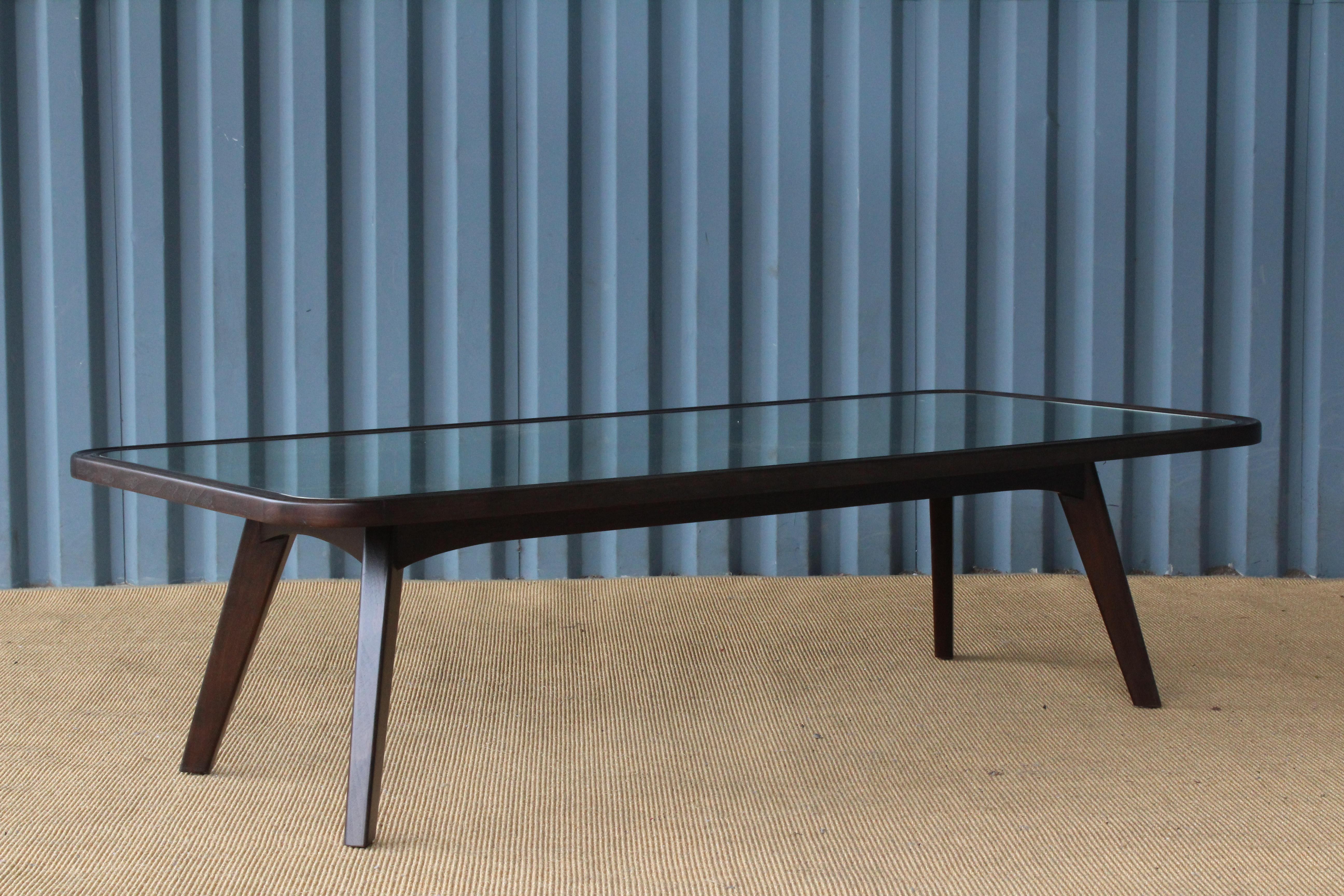 Custom midcentury style coffee table. Constructed in walnut with an antique mirrored top.