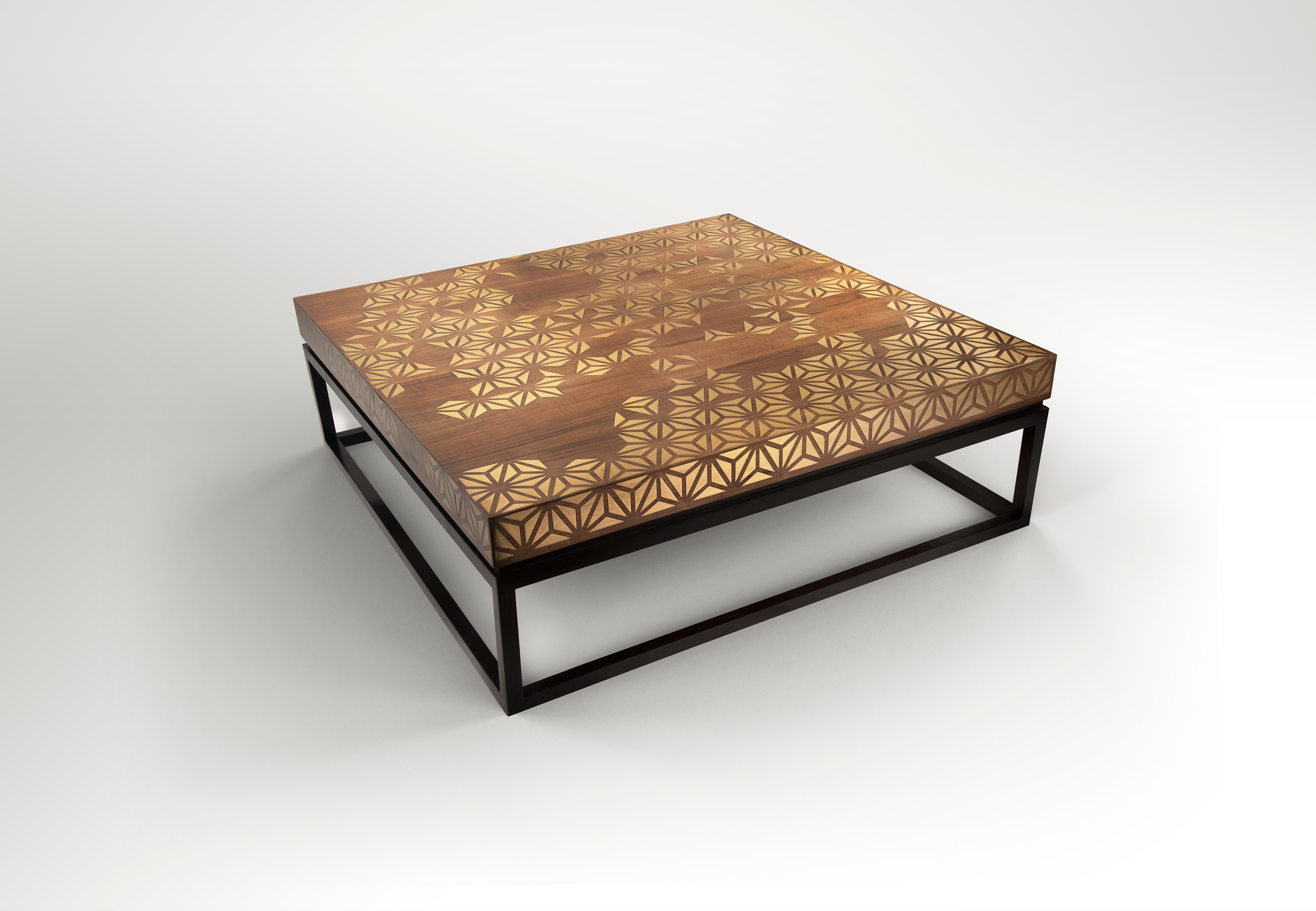 Walnut Coffee Table with Handcrafted Brass Inlay and Black Lacquered Legs. 
Perfection is one of our signature tables where many textures are charmingly infused to make this table a design showpiece. It is made from massive walnut wood infused with
