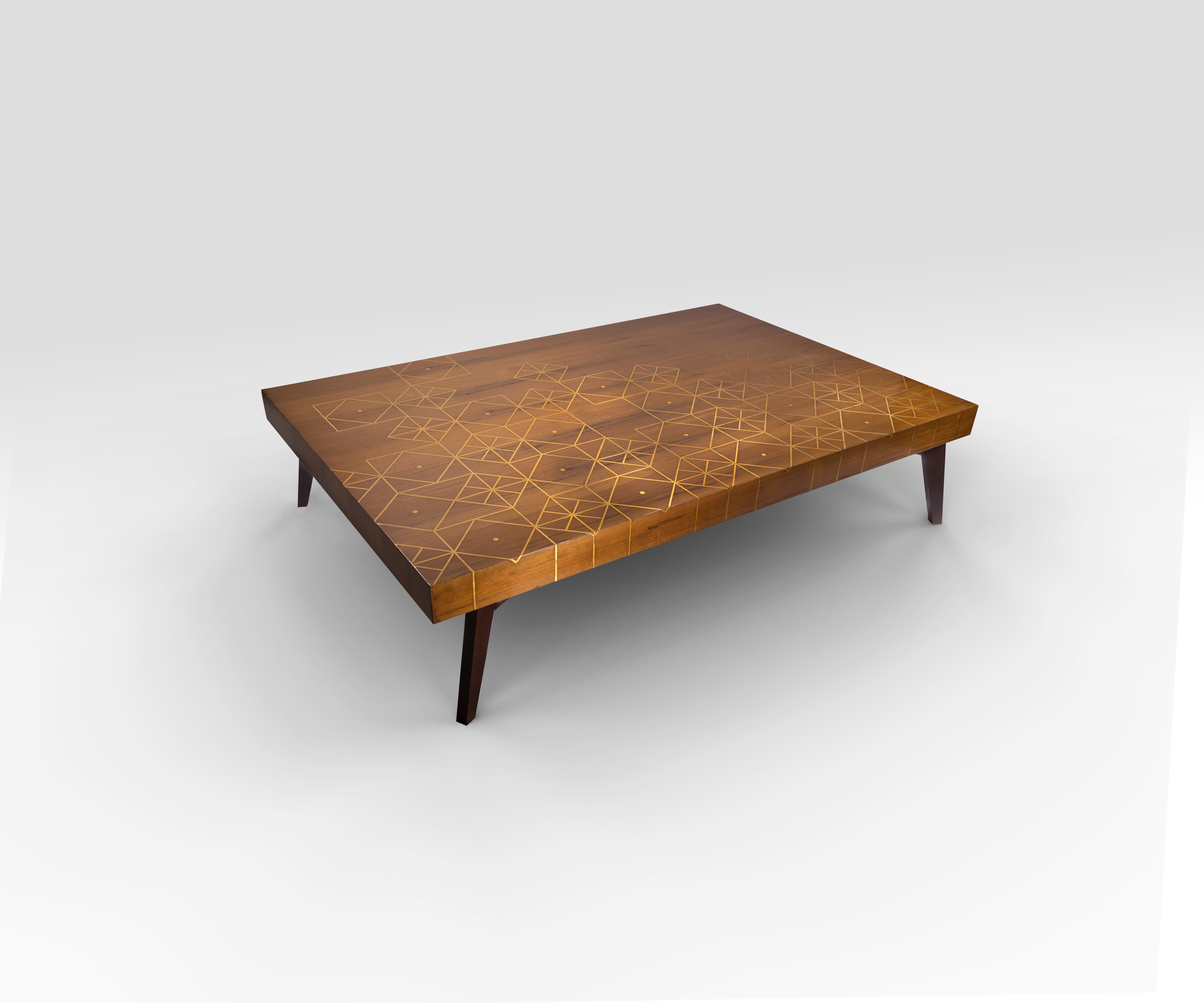 Walnut Coffee Table with Handcrafted Brass Inlay Inspired from a Nubian Motif. 
Our Wonder coffee table is more than just a handcrafted furniture showpiece! The exquisite piece is made from massive walnut wood and inlayed with an asymmetric brass