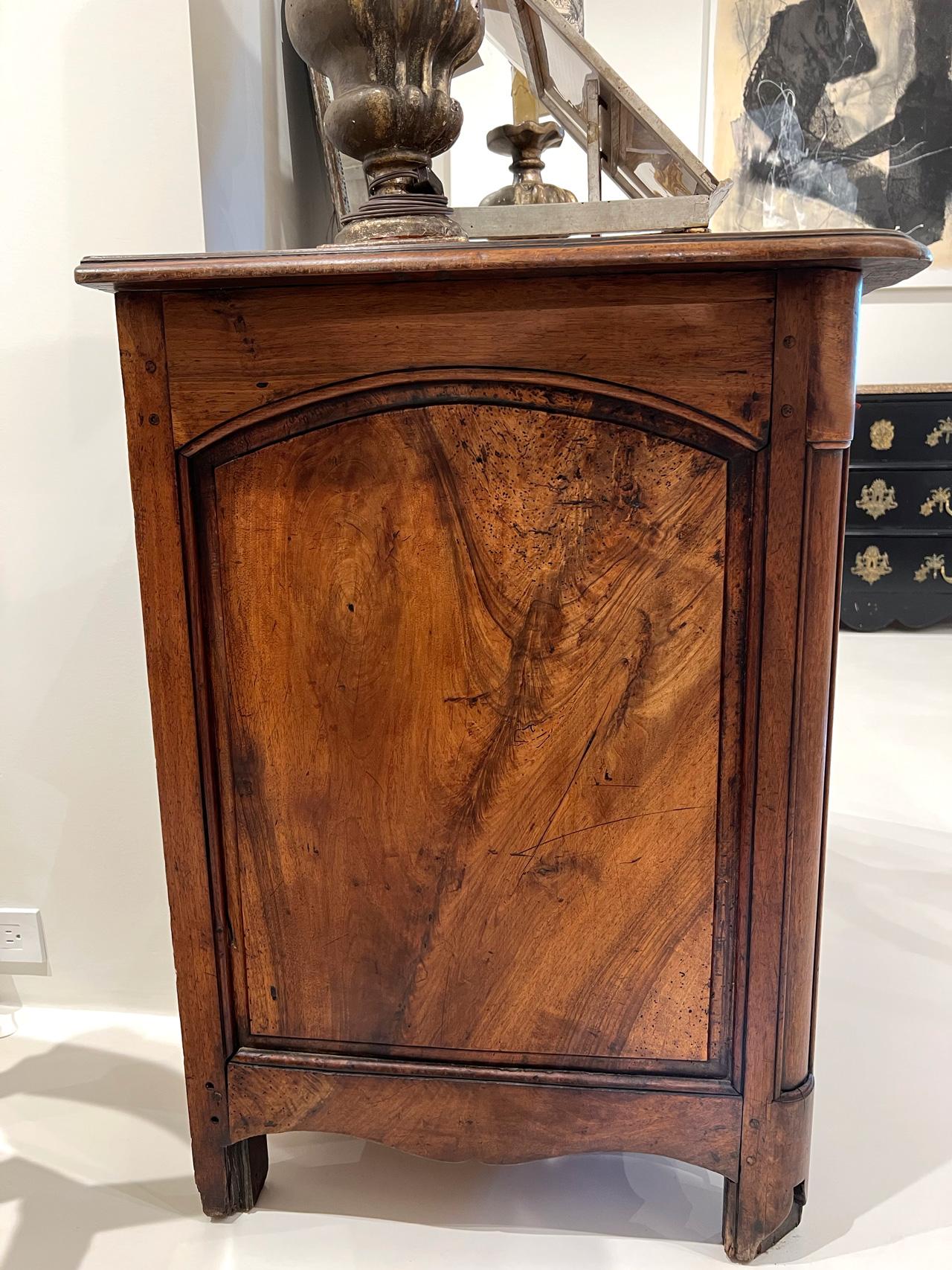 This refined Walnut Commode has two small top drawers and two larger bottom drawers. There are bronze eschutions and pulls on the drawers as well as one decorative bronze medallion at top center of chest. The base is beautifully curved with a carved