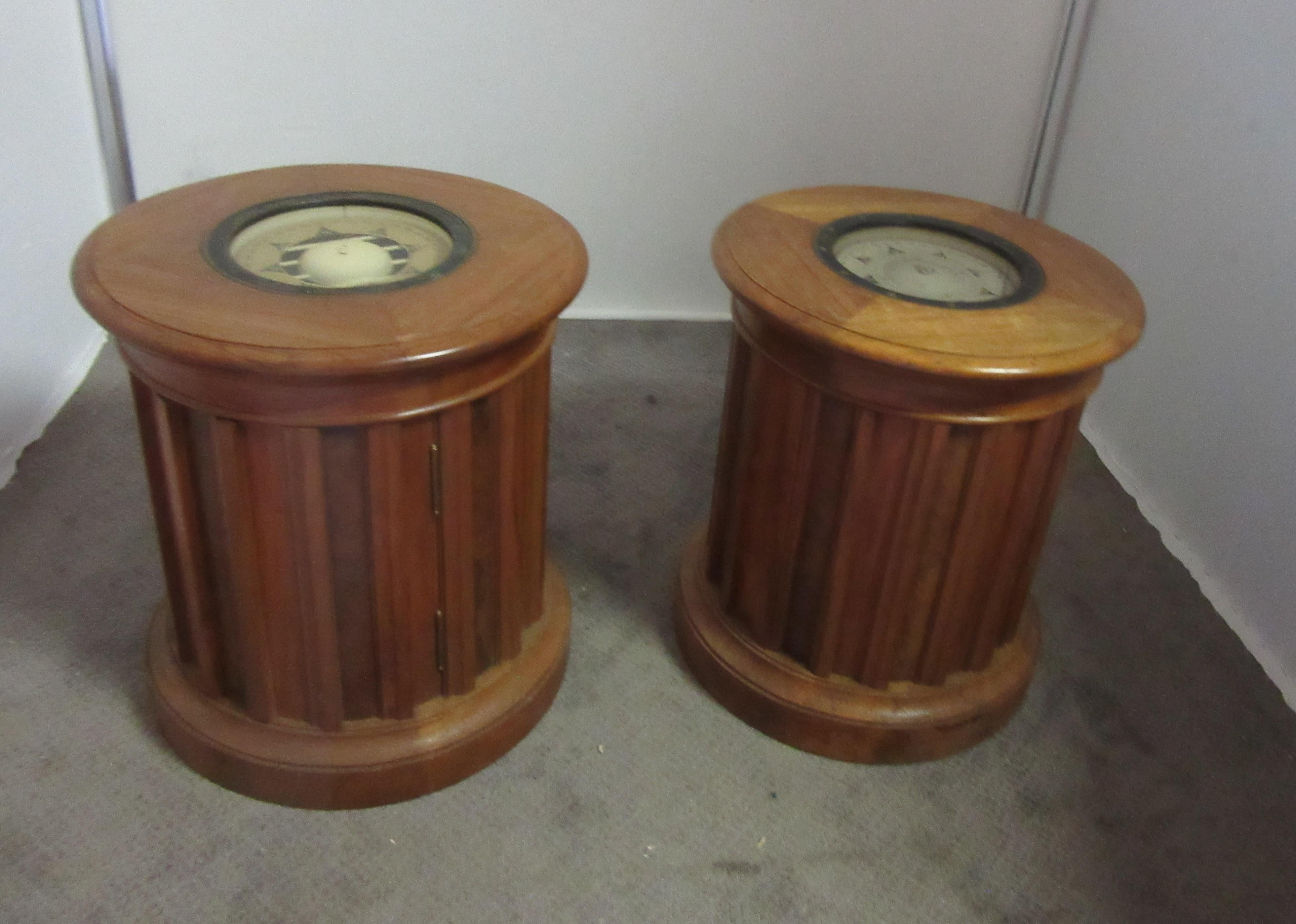 Pair of walnut tables with compasses inserted in the top. Compasses are gimbaled, meaning they float independently even if the tables are tilted. Doors on the bottom open up for storage. Slats, running around the tables, are alternating walnut and