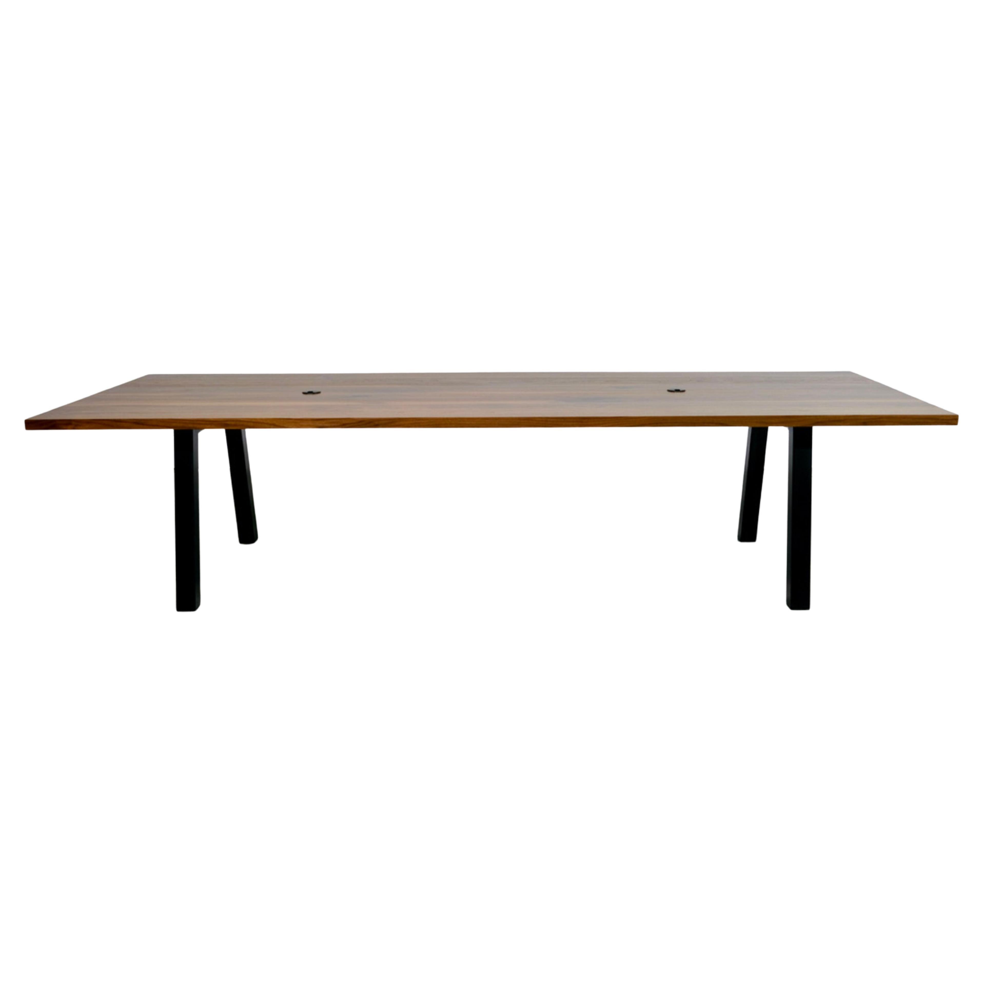 This solid wood conference table is built to last. Featuring satin black powder coated steel legs a solid wood top and optional grommets of your choice. Because each piece is handcrafted by our skilled team, you can be sure that your new table will