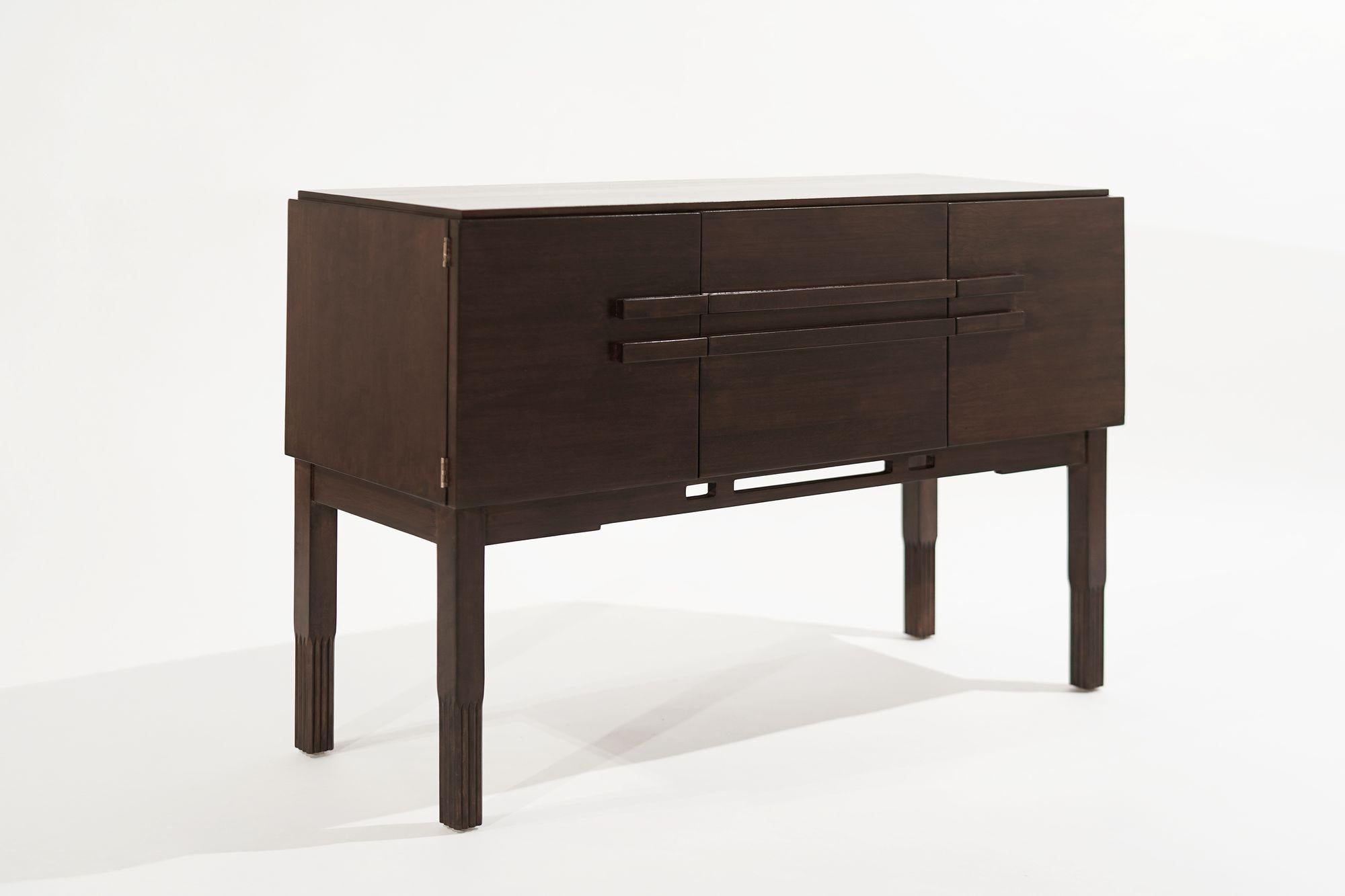 A console table executed in walnut by John Stuart, circa 1950-1959. Completely restored, featuring two drawers and side doors that open up to reveal shelving.
 
Other designers from this period include Paul McCobb, Vladimir Kagan, Hans Wegner, Gio