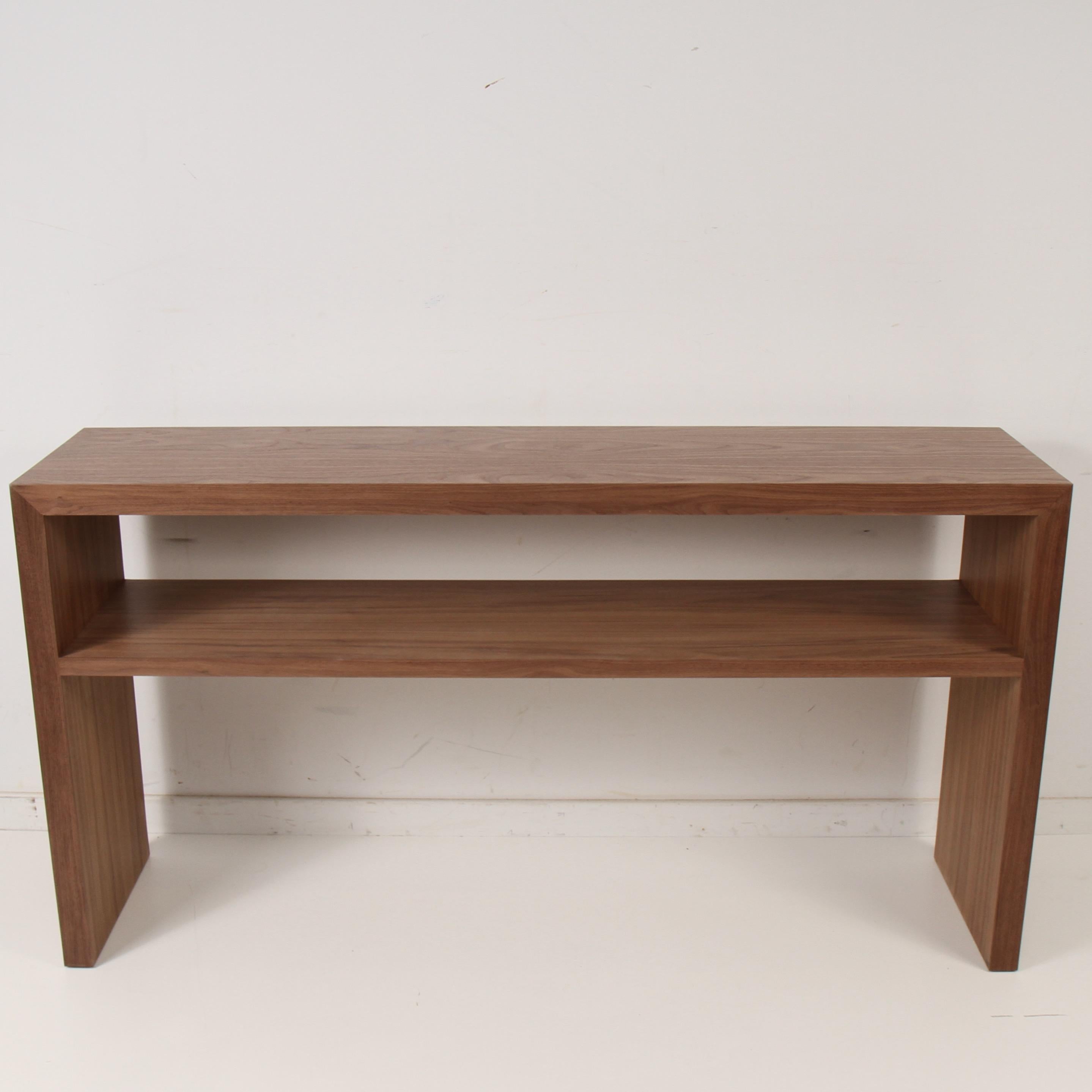 Modern console table by Samuel Greg. Made of walnut, with a lower shelf that stretches across table 23
