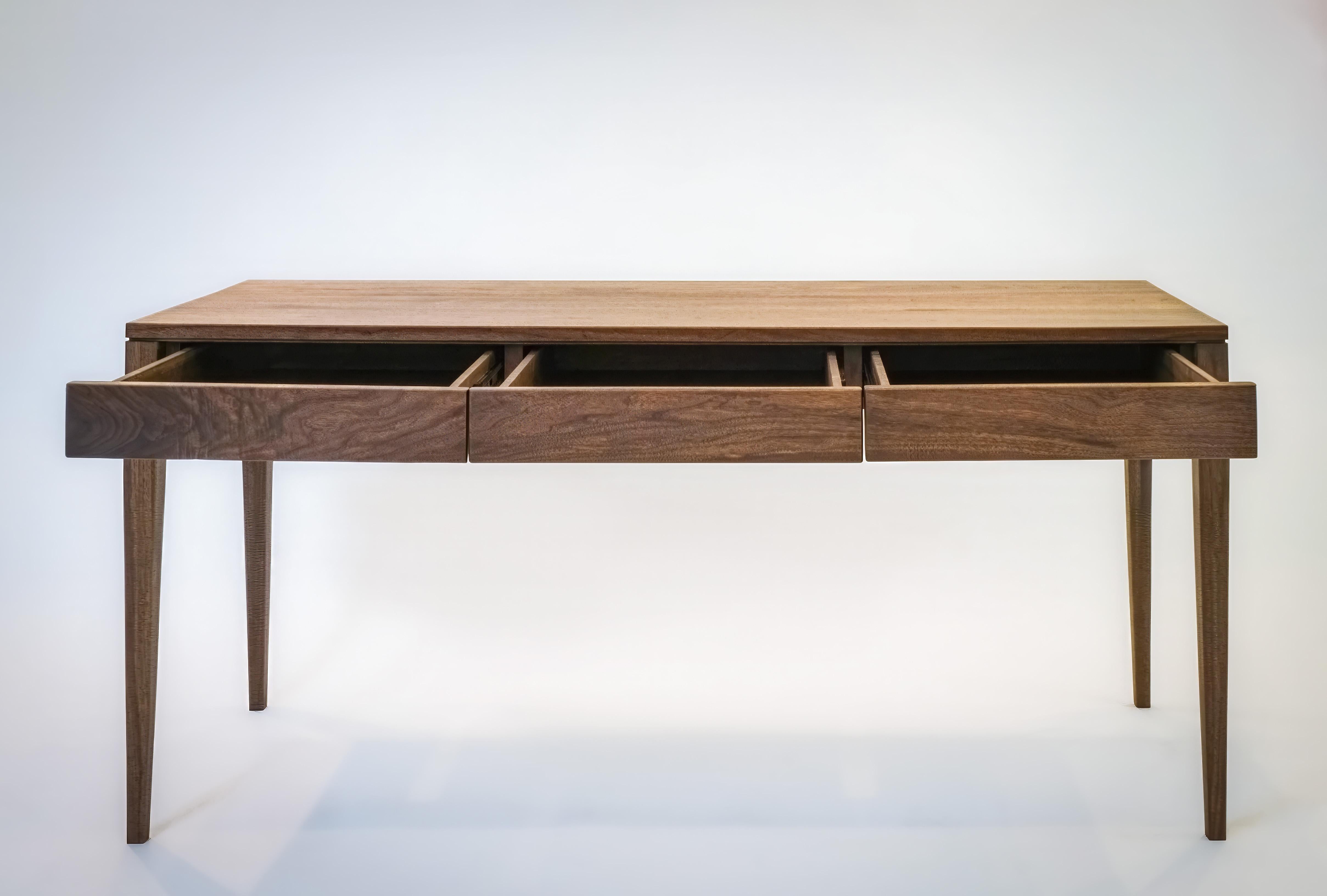 This molten grain walnut table spans in magical round over edges.
It is handcrafted in solid walnut with tapered legs, a perfect setup for a console or an artist's desk. Drawer fronts are one continuous board for a grain match. 




Own a