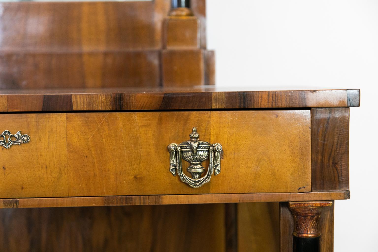 The top of this English William IV console table has the original finish and patina. The frieze has a medallion and leaf spear carved in high relief. The front legs have a scrolled shape with stylized acanthus leaves on the top and bottom which are