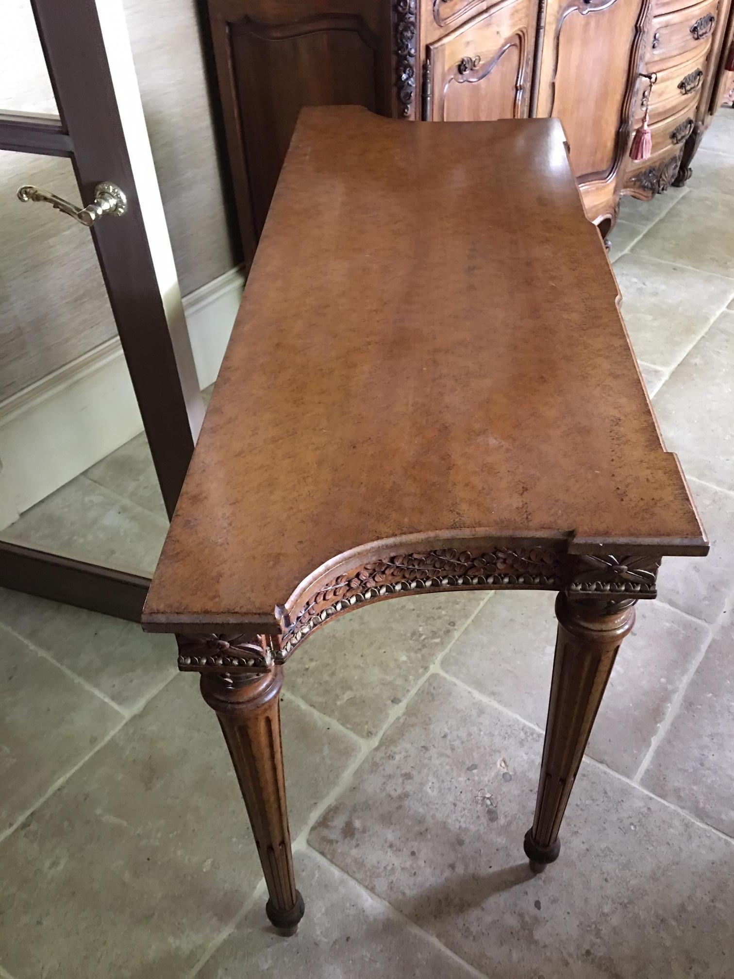 20th century walnut console with a carved decorative apron and two drawers.  Width of back of console is 50