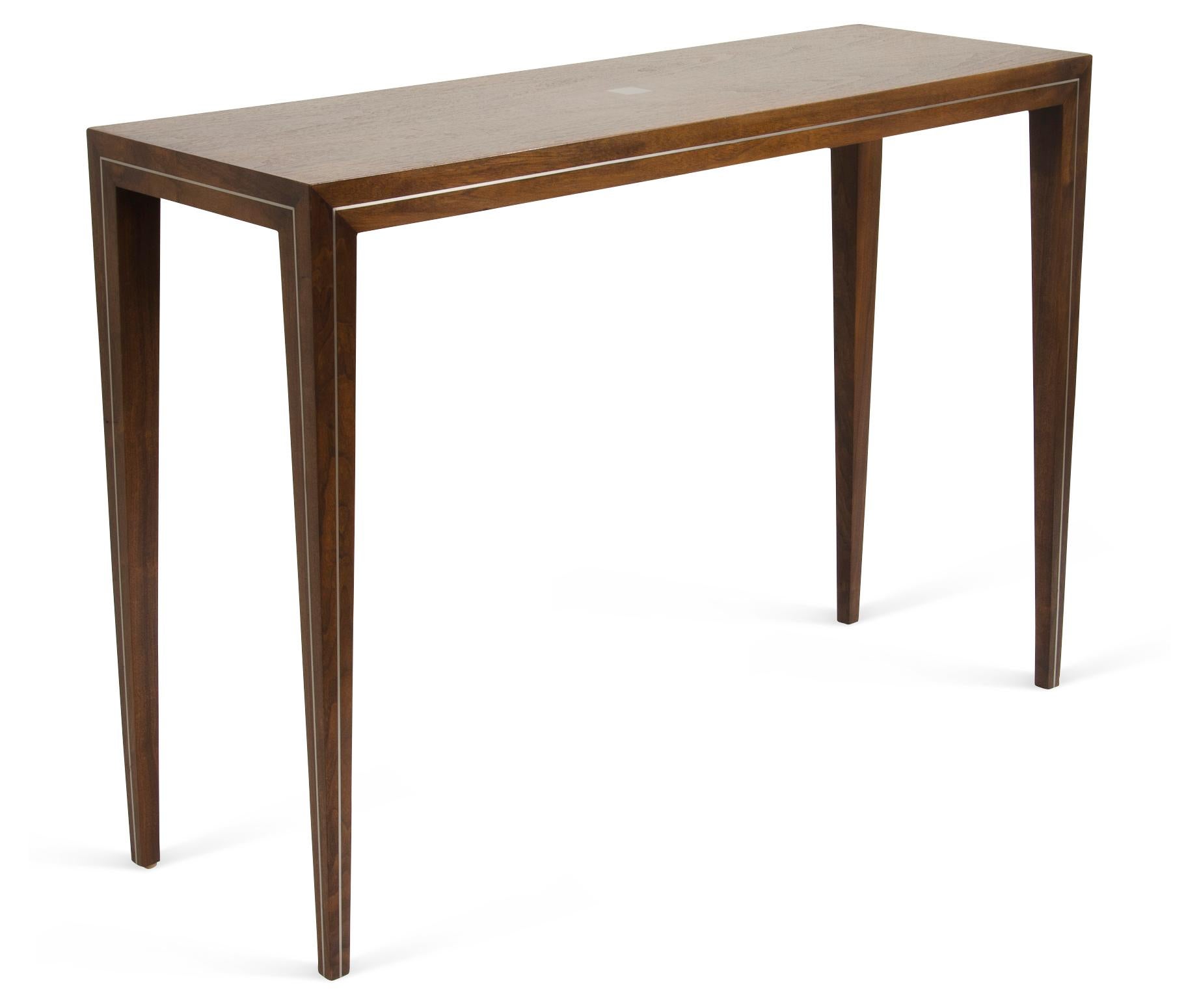 The walnut console is a handcrafted edition, with tapered legs and brass or aluminum inlays, mitred corners and traditional joinery. Custom sizes and finishes available.