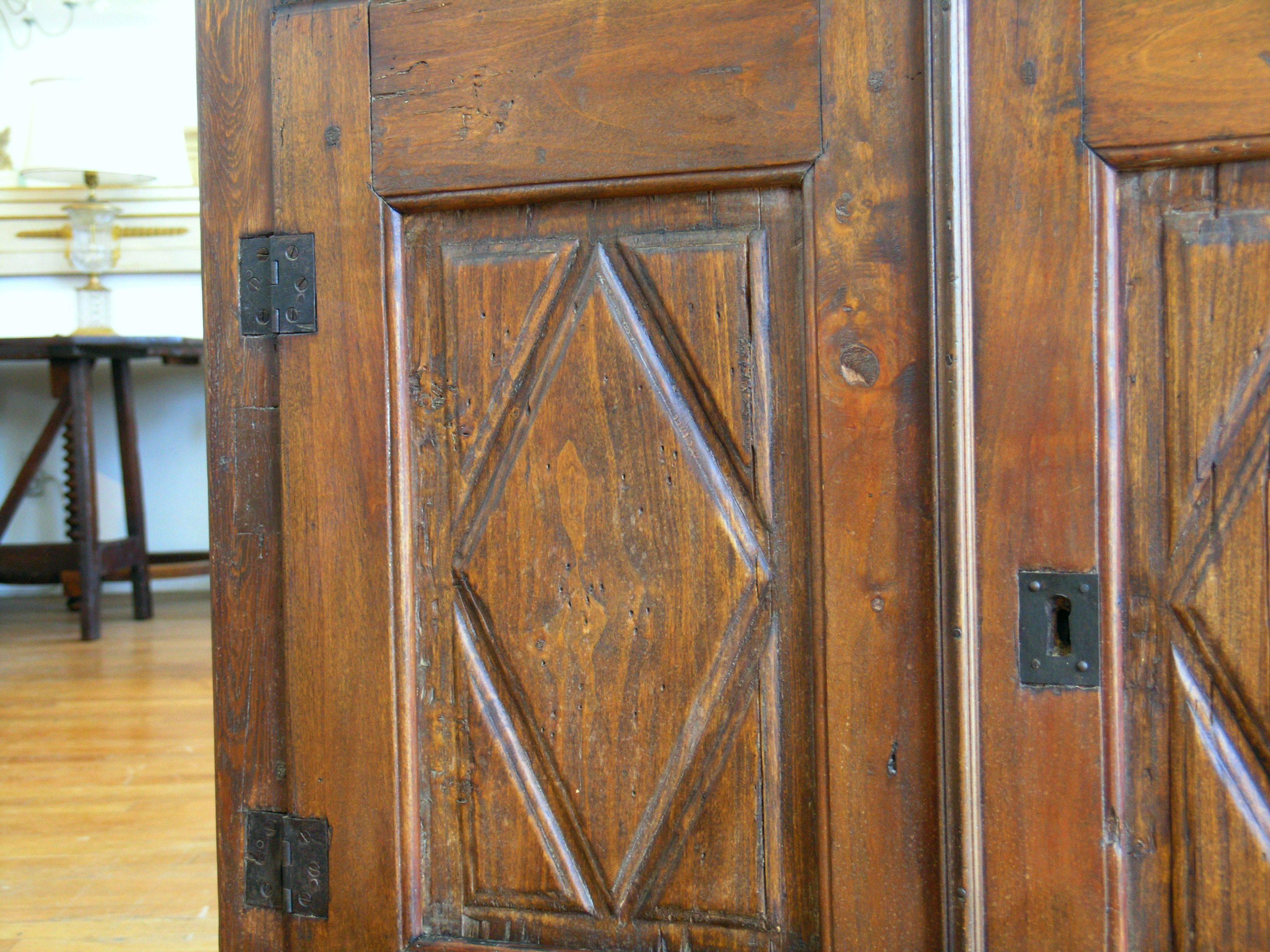 Rectangular top with molded edge over a long drawer, above a pair of paneled doors carved with diamond-shaped motifs, raised on plinth base.