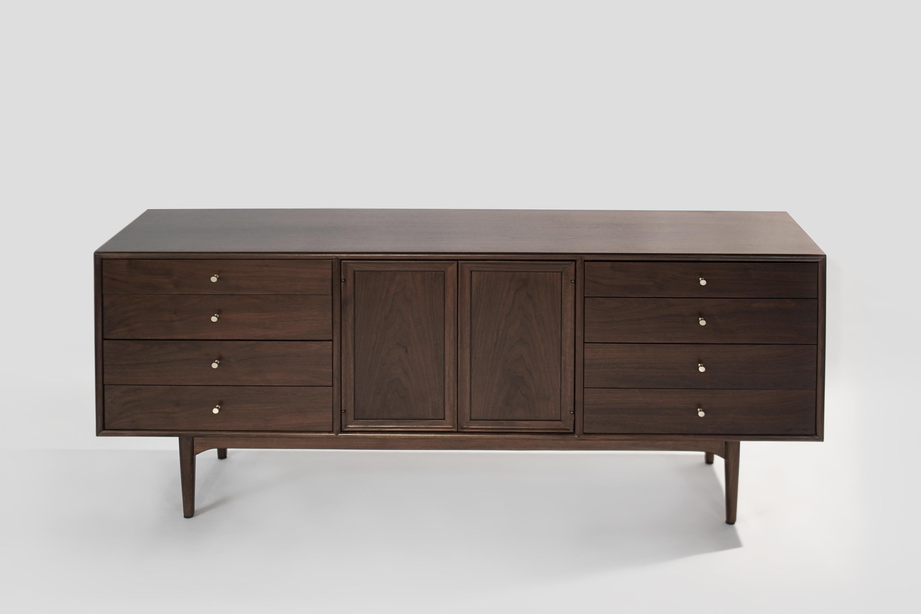 Credenza or dresser designed by Kipp Stewart for Drexel, circa 1950s. Executed in walnut, showcasing its beautiful natural grain. A total of 11 drawers provides ample storage space.